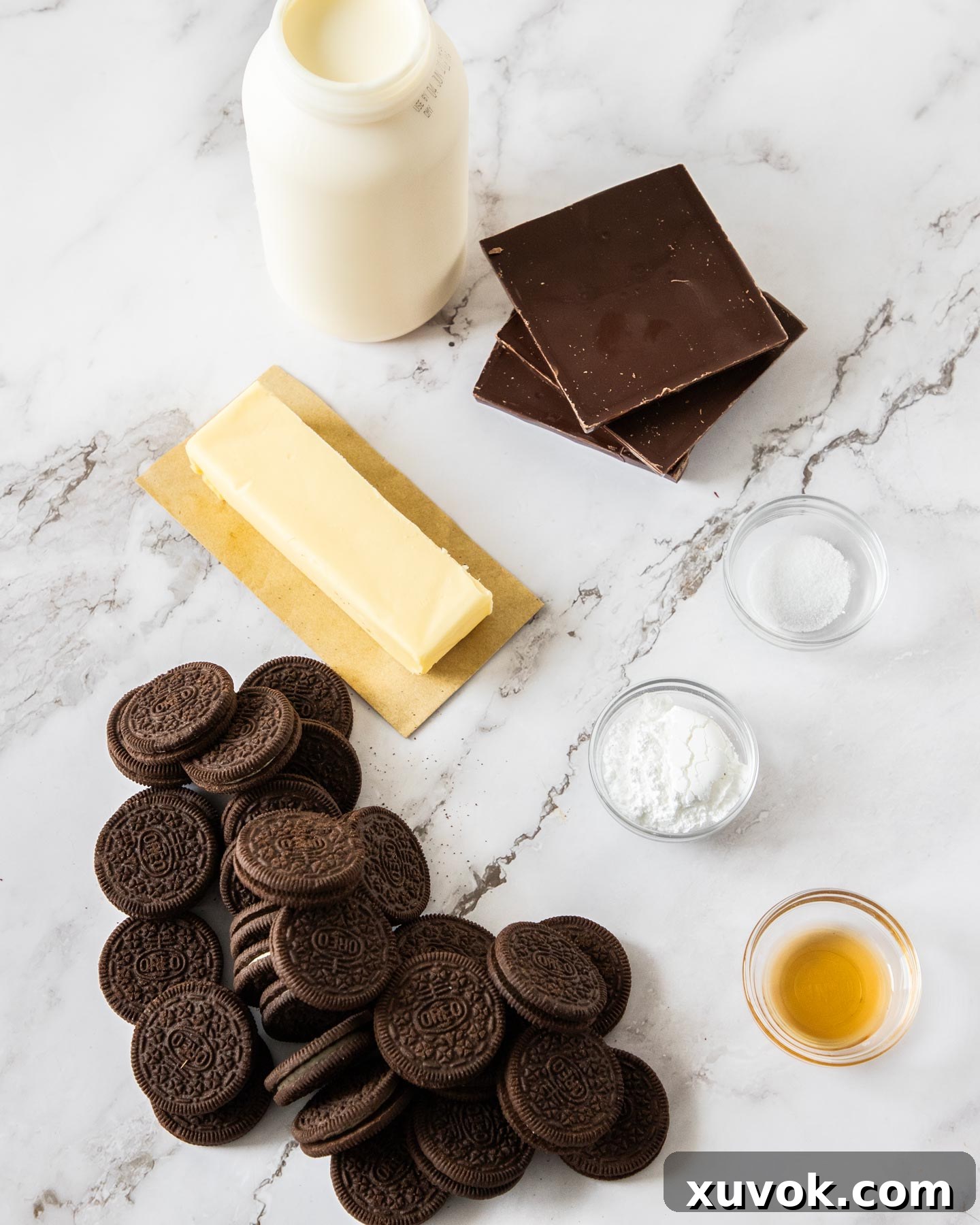 Ingredients for chocolate mousse tart on a marble surface.