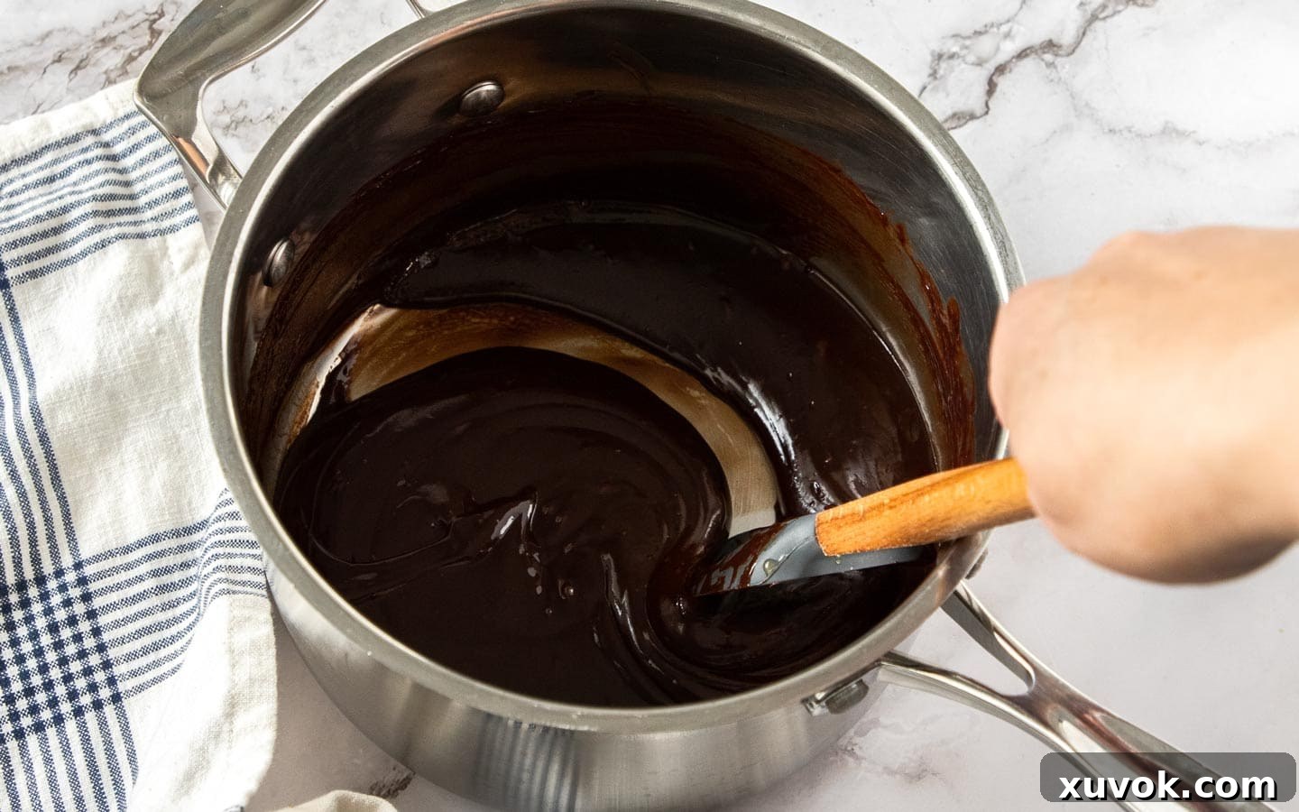 The chocolate ganache mixture in a saucepan.