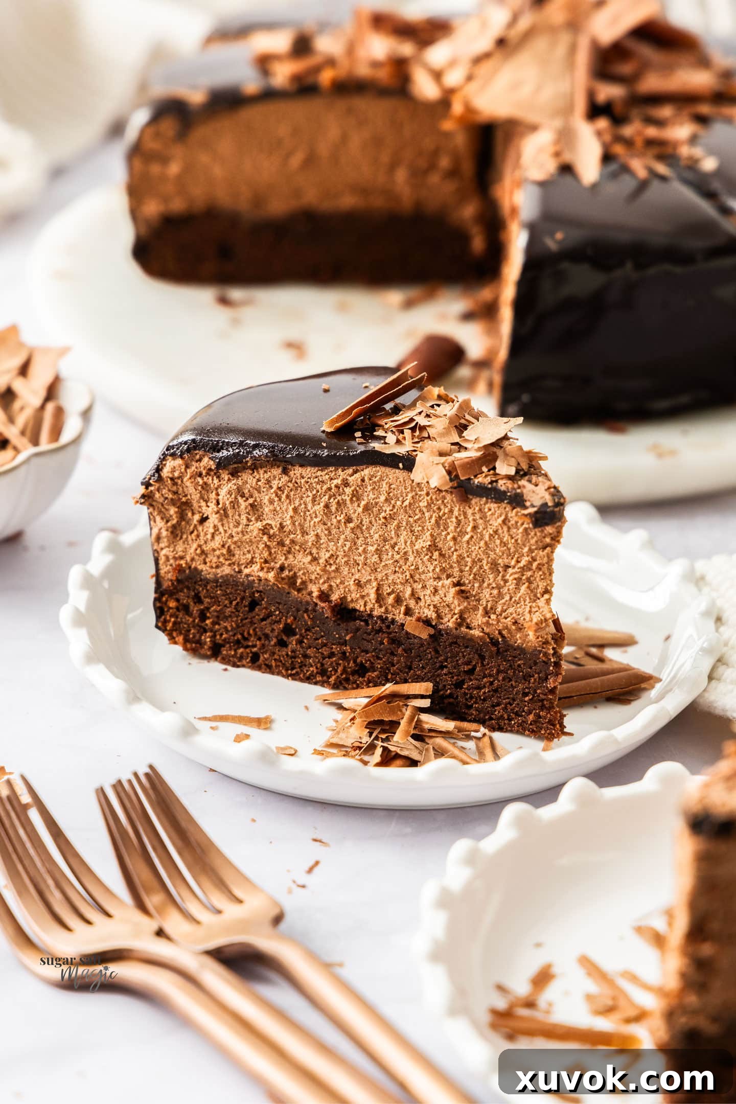 A slice of chocolate mousse cake on a dessert plate.
