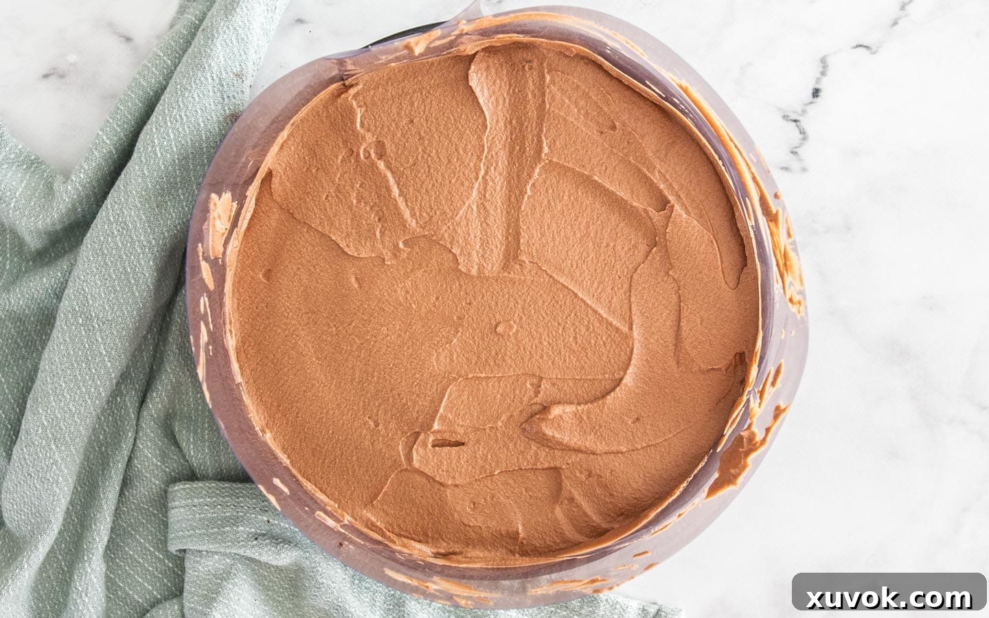The chocolate mousse spread over the cake.