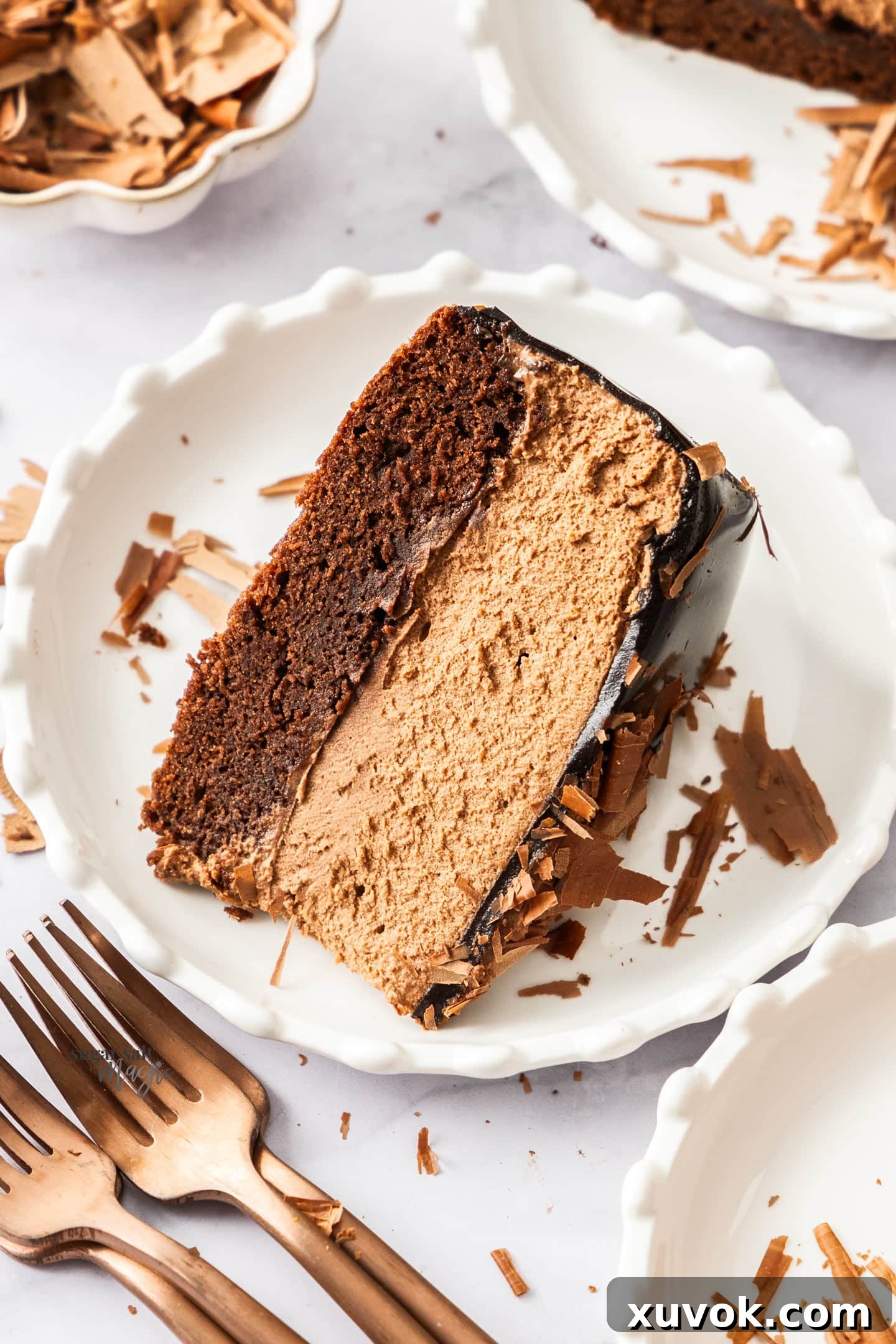 A slice of chocolate mousse cake on a dessert plate.