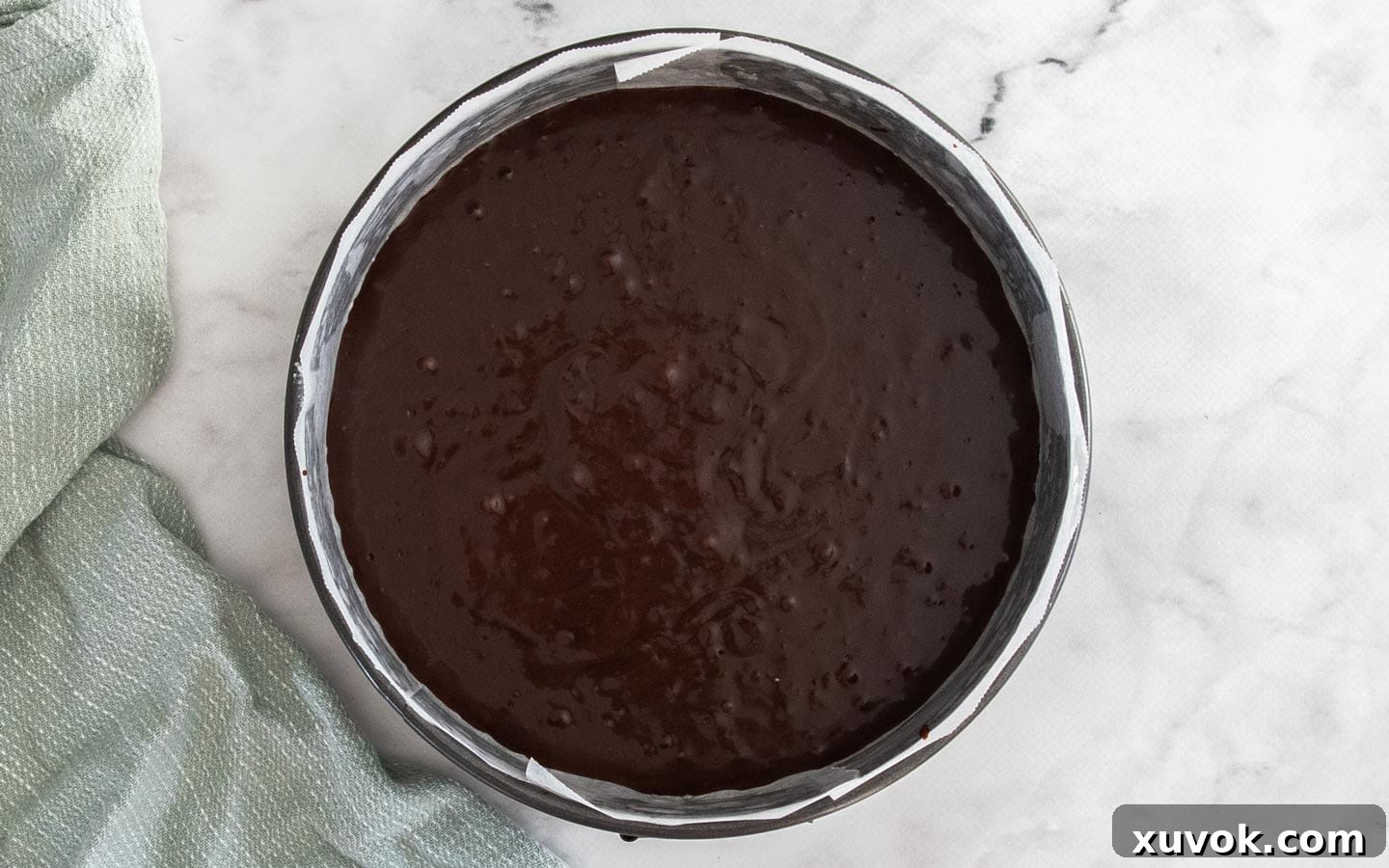 The cake batter in a round cake pan.