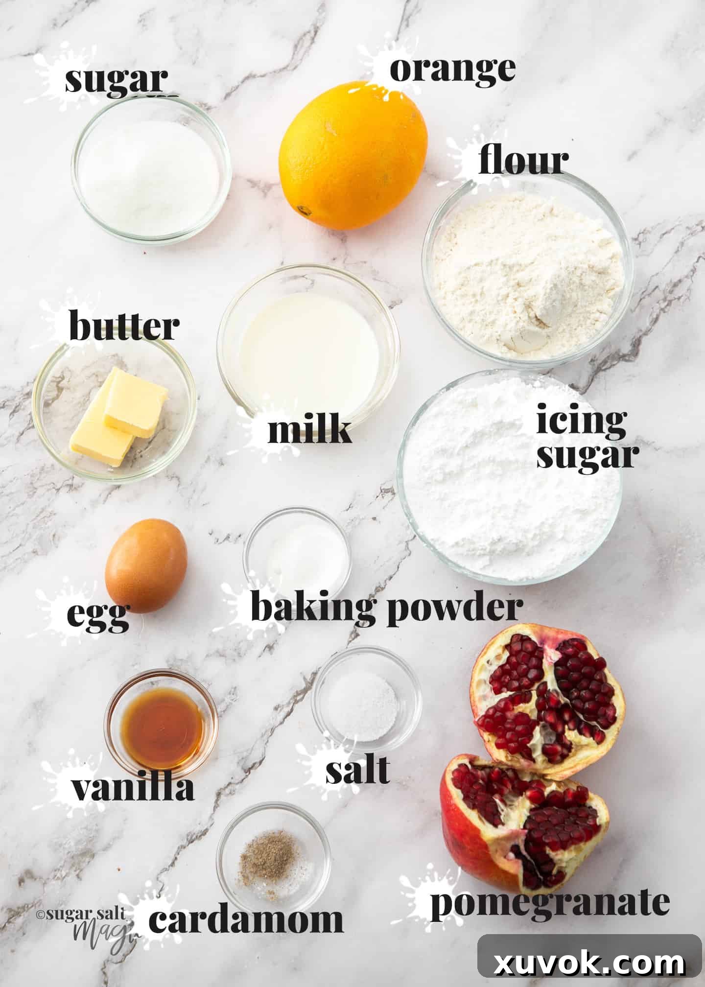 A curated collection of ingredients for making orange donuts with pomegranate icing, neatly arranged on a pristine marble countertop. Components include fresh oranges, pomegranate, flour, sugar, butter, eggs, and milk, alongside measuring cups and a whisk, all ready for baking.