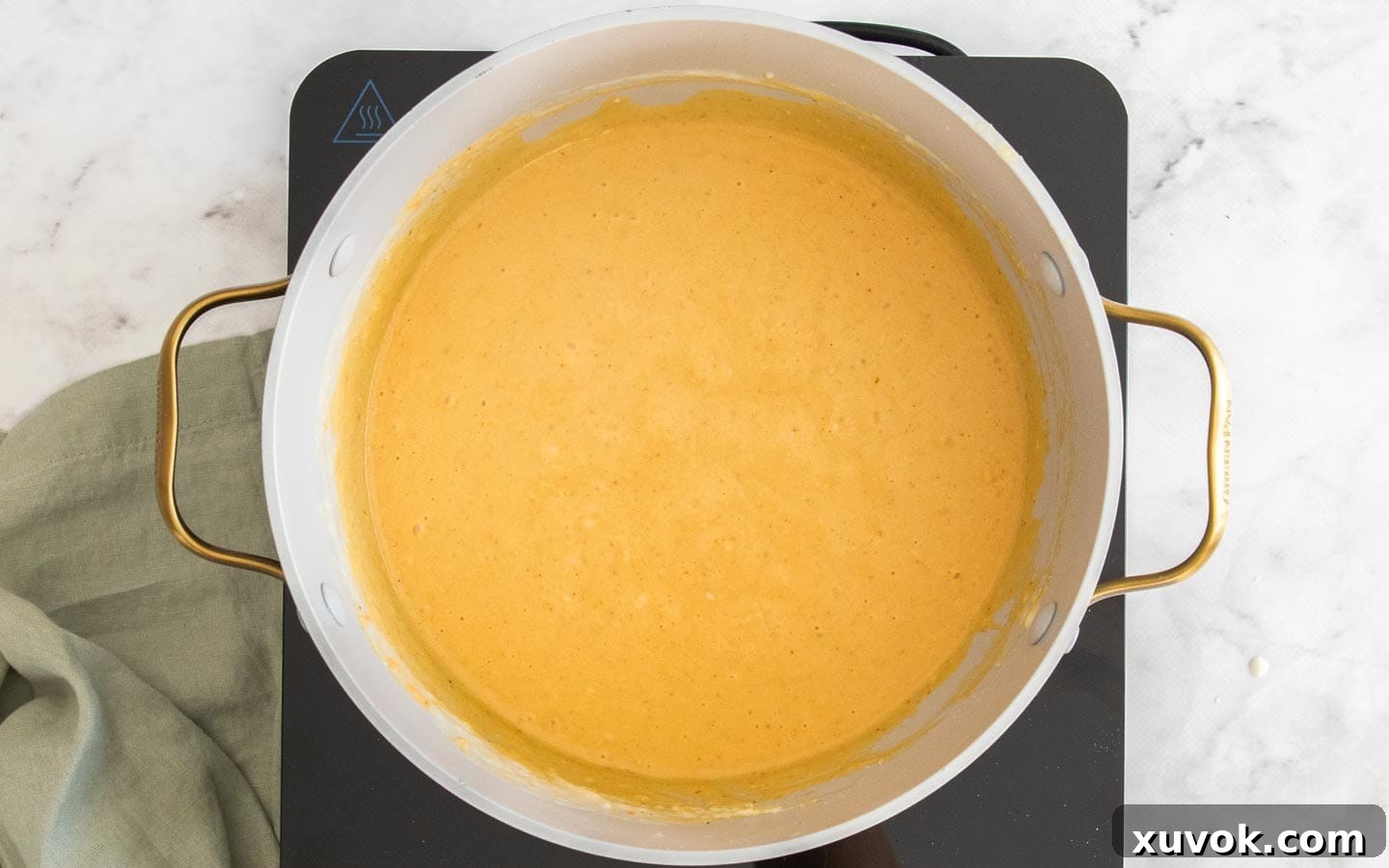 The sauce thickening in a pot.
