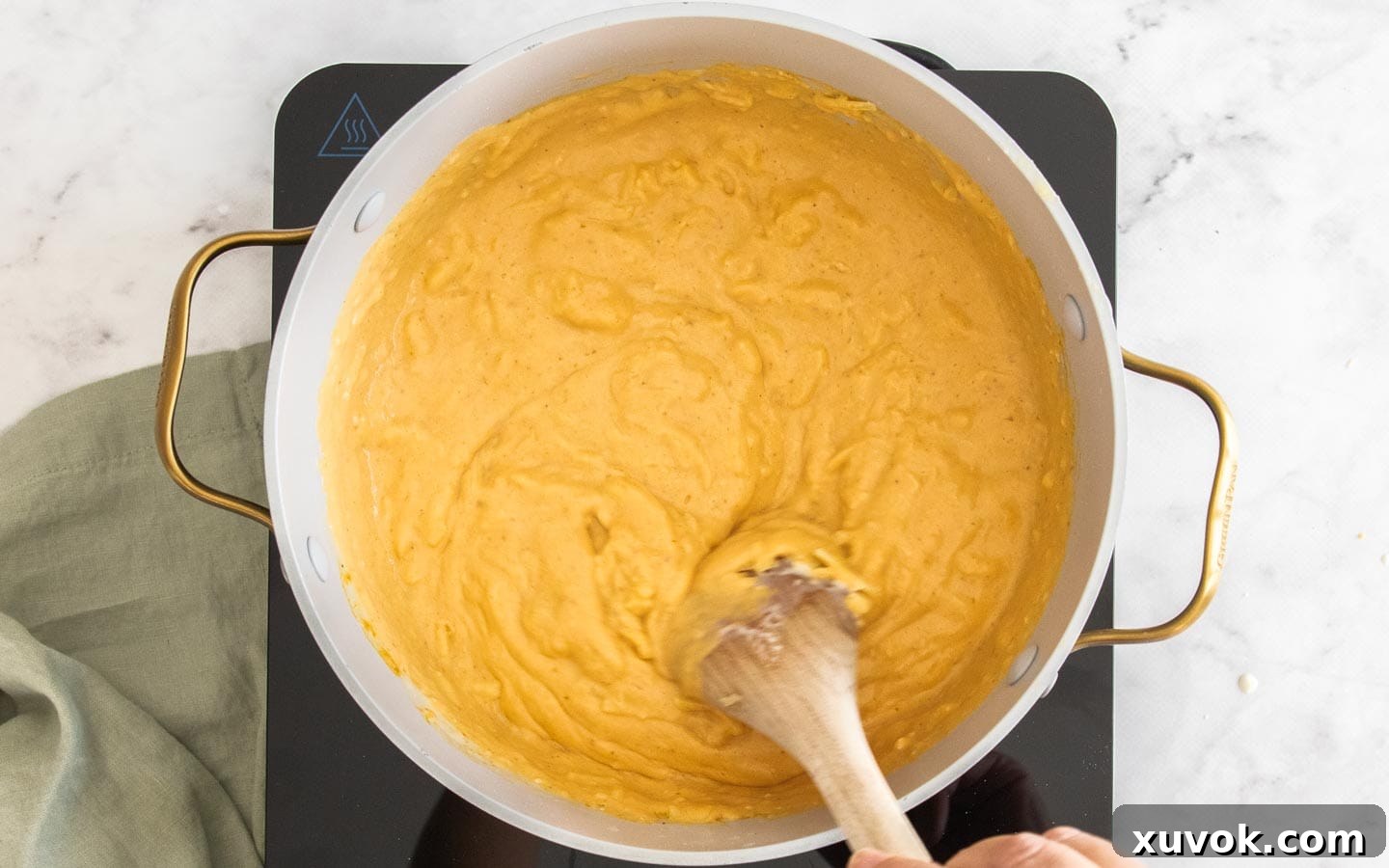 Melting the cheese into the sauce.