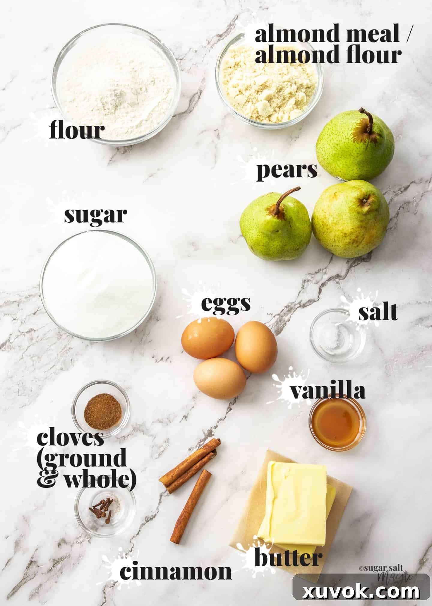 Ingredients for pear almond tart on a marble surface.