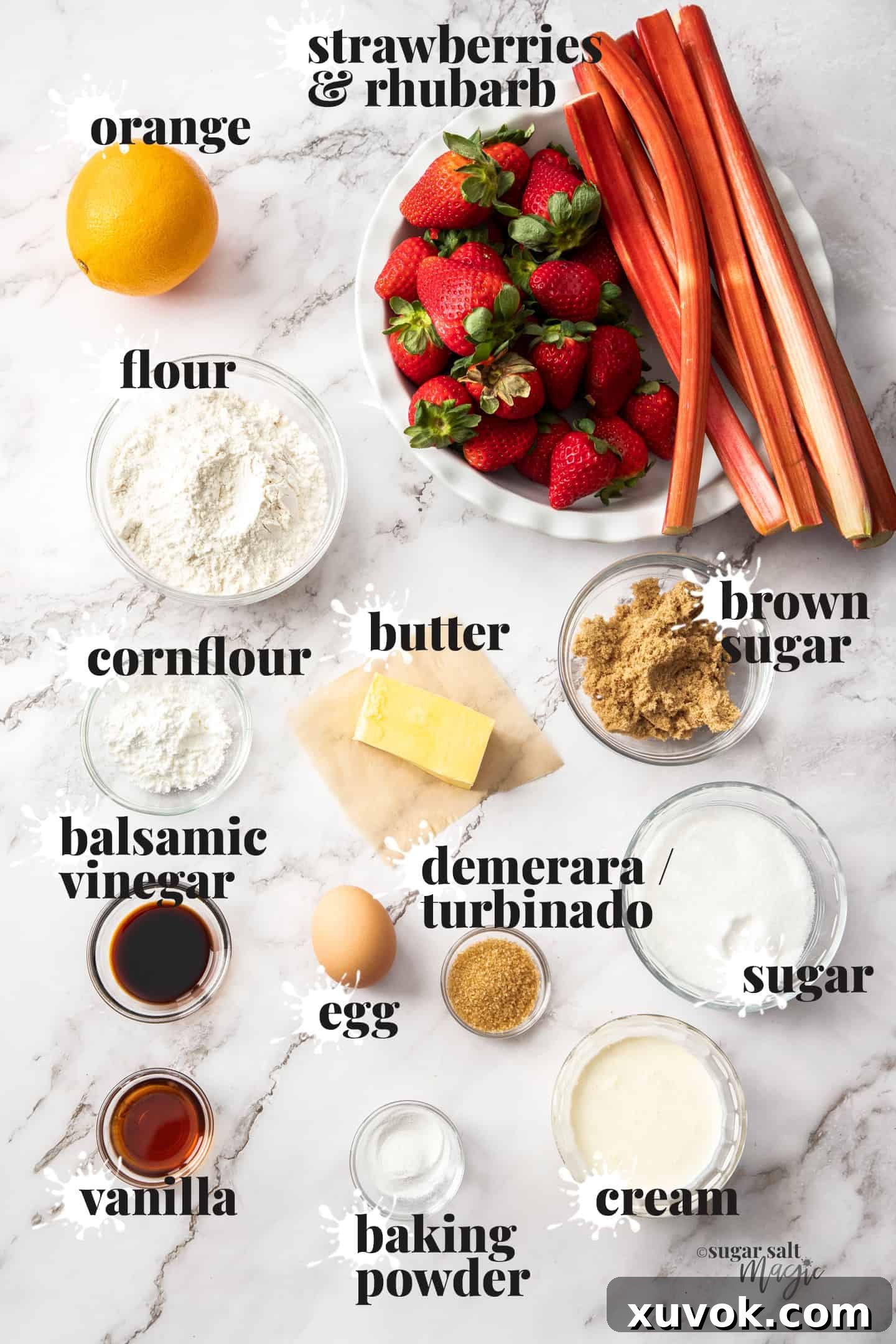 Ingredients for strawberry rhubarb cobbler recipe laid out on a marble benchtop.
