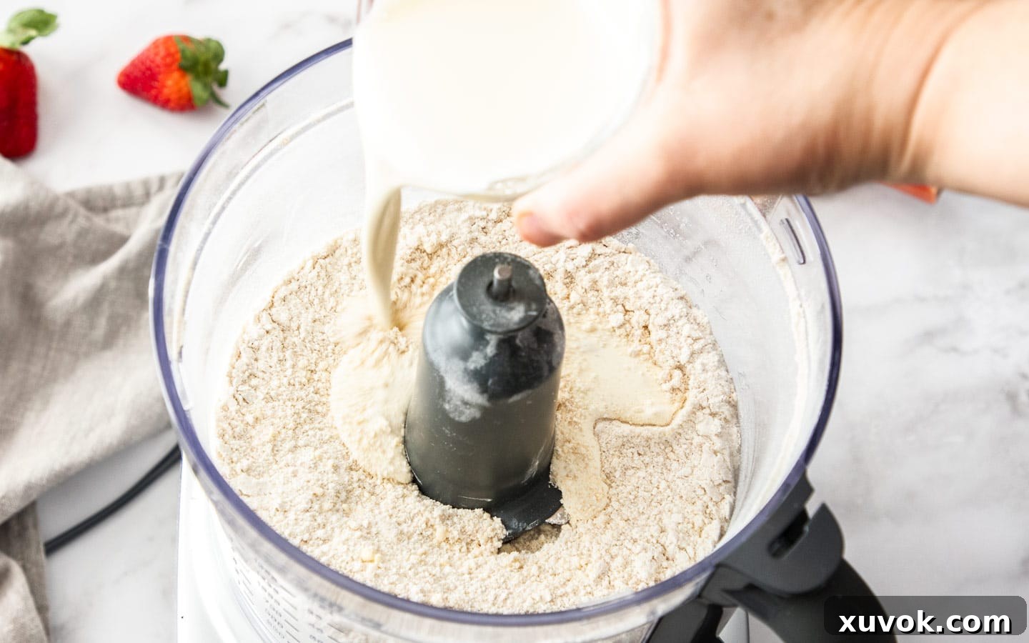 Adding cream to the dry ingredients.
