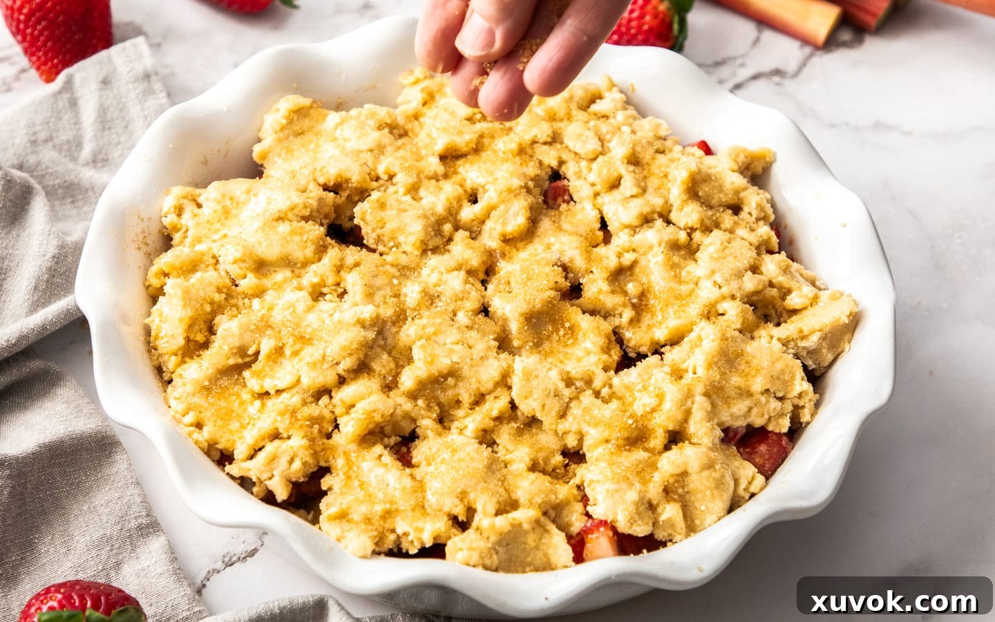 Adding sugar to the cobbler topping.