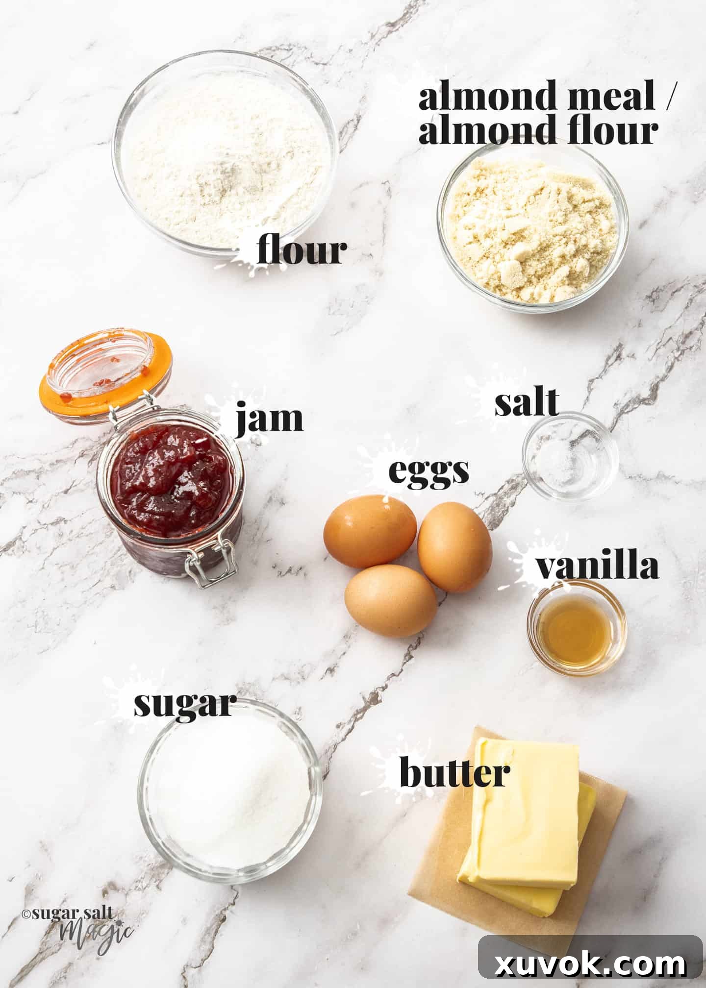 Ingredients for bakewell tart on a white marble surface.