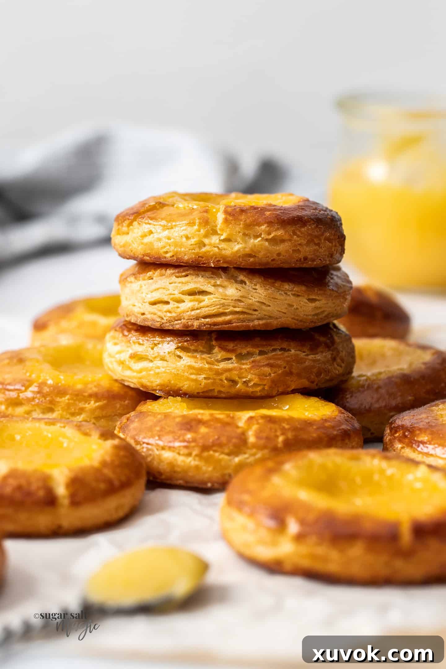 A stack of golden-brown Danish pastries filled with bright lemon curd, ready to be enjoyed.