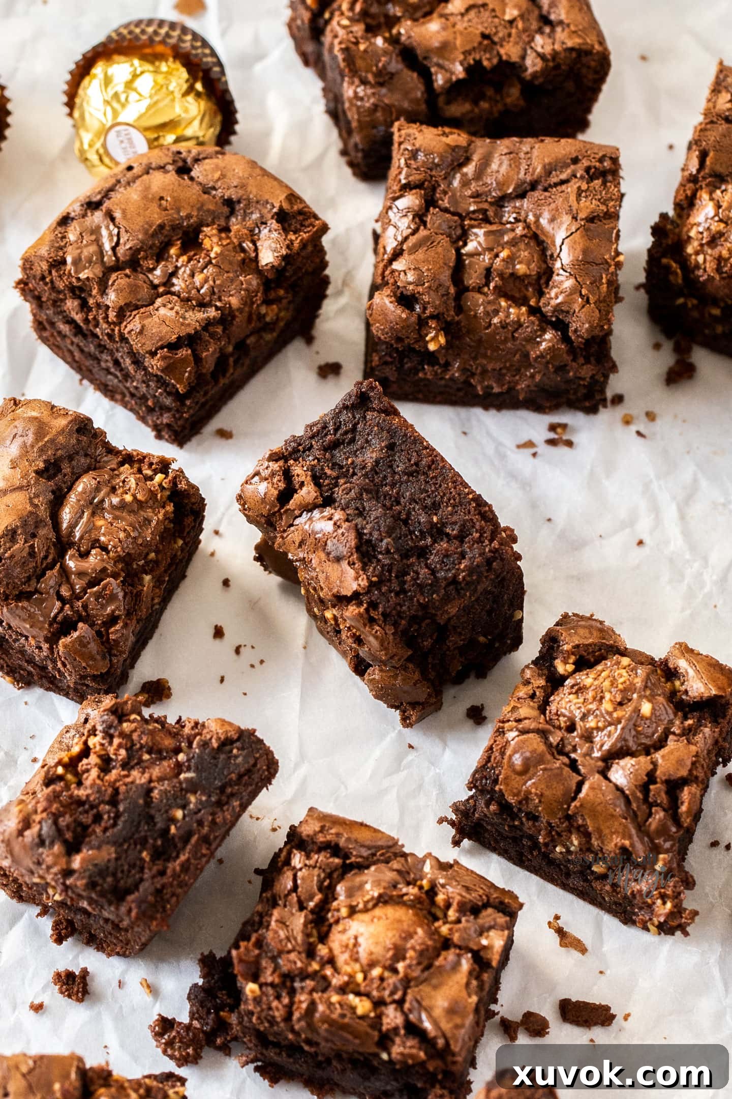 Top-down view of a batch of freshly baked Ferrero Rocher brownies, generously filled with chocolates and Nutella swirls.