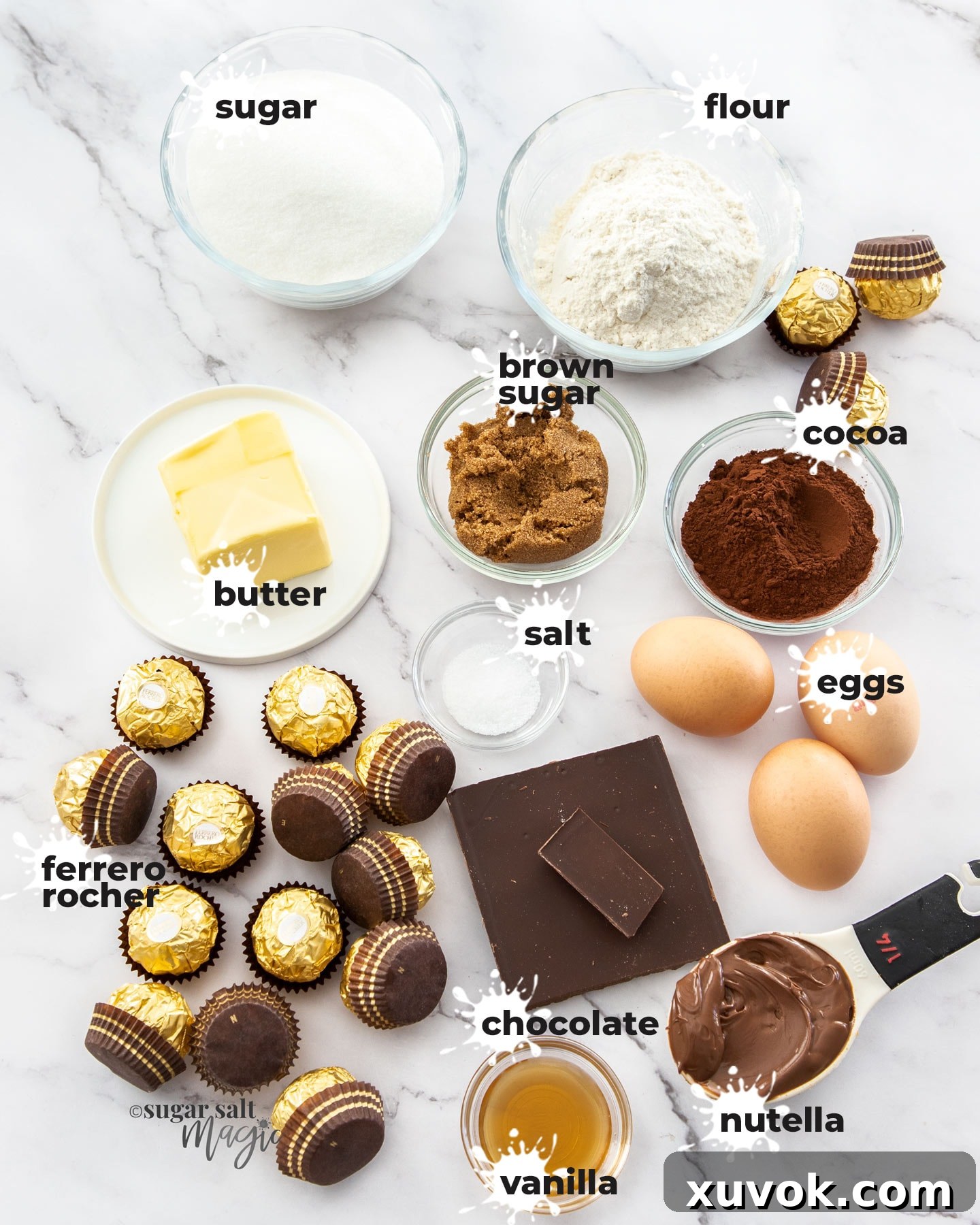 A flat lay photograph displaying all the fresh ingredients required to make delicious Ferrero Rocher Brownies, including chocolates, cocoa, and butter.