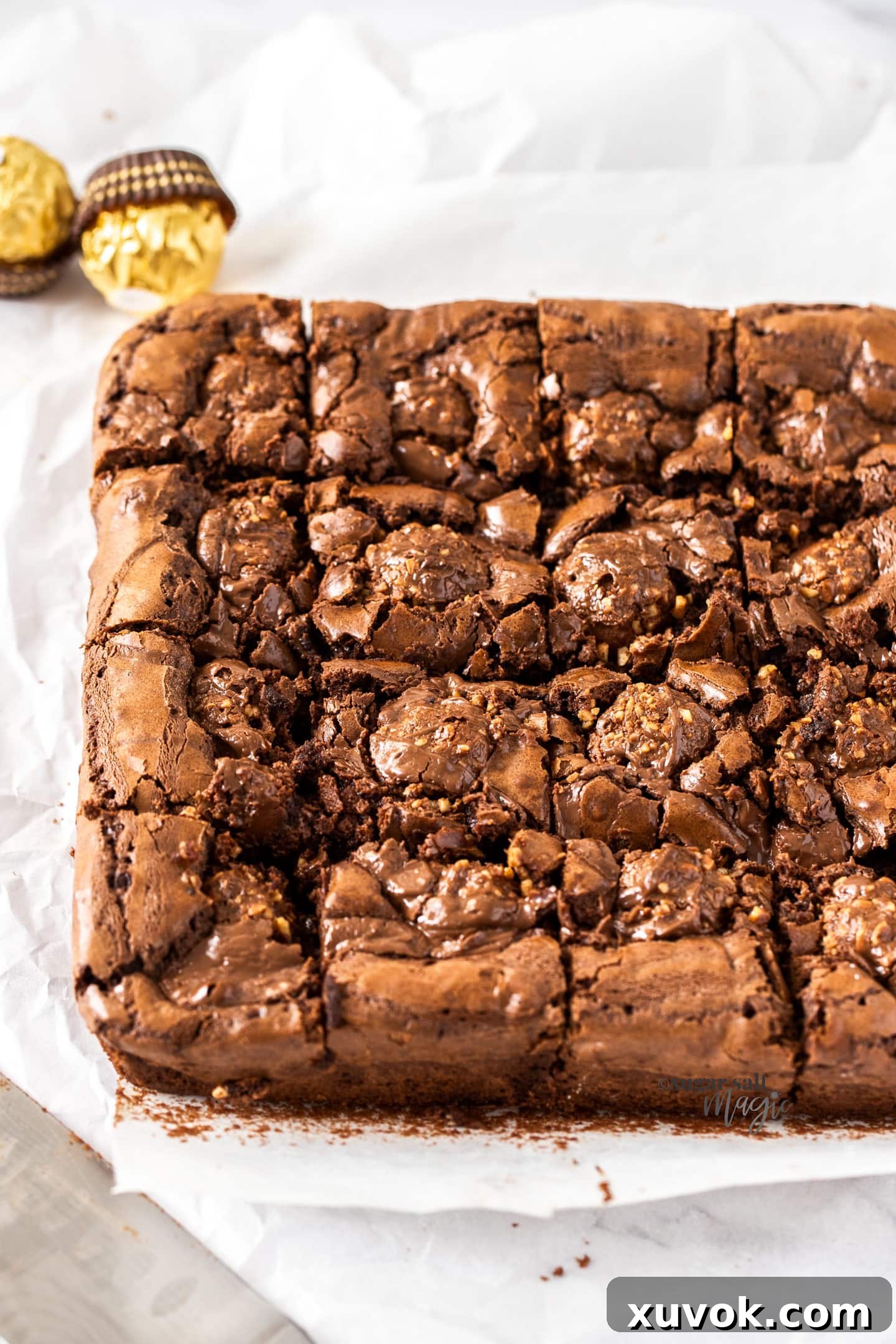 A batch of fudgy Ferrero Rocher brownies perfectly cut into squares, ready to be served.