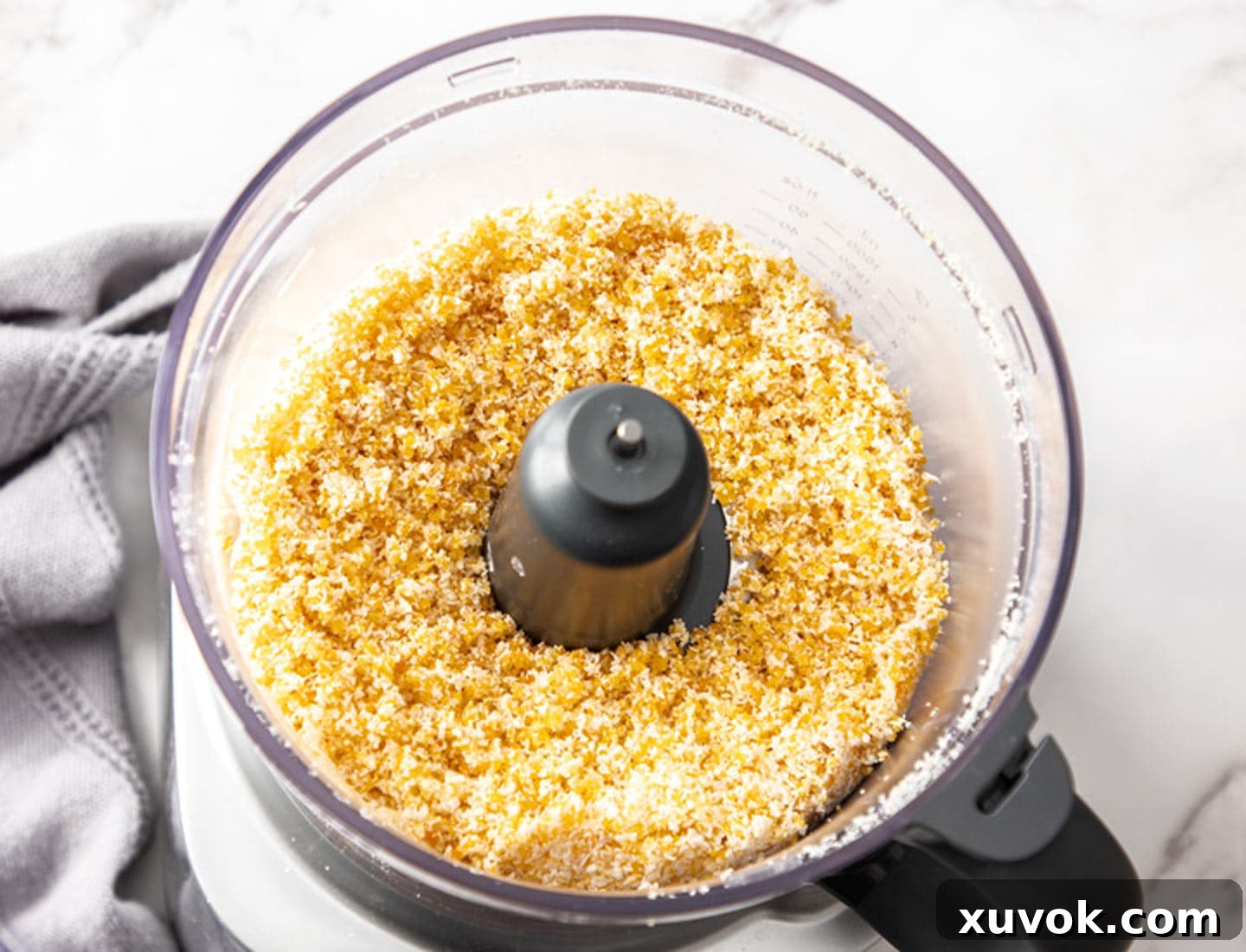 The processed ingredients in a food processor, now a fine, uniform mixture, ready for liquid.