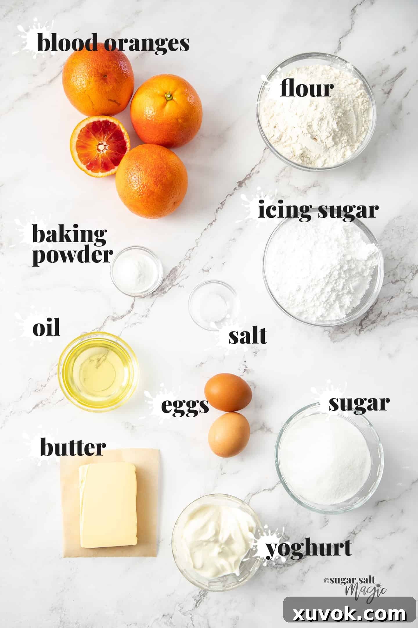 Ingredients for blood orange loaf cake on a marble benchtop.