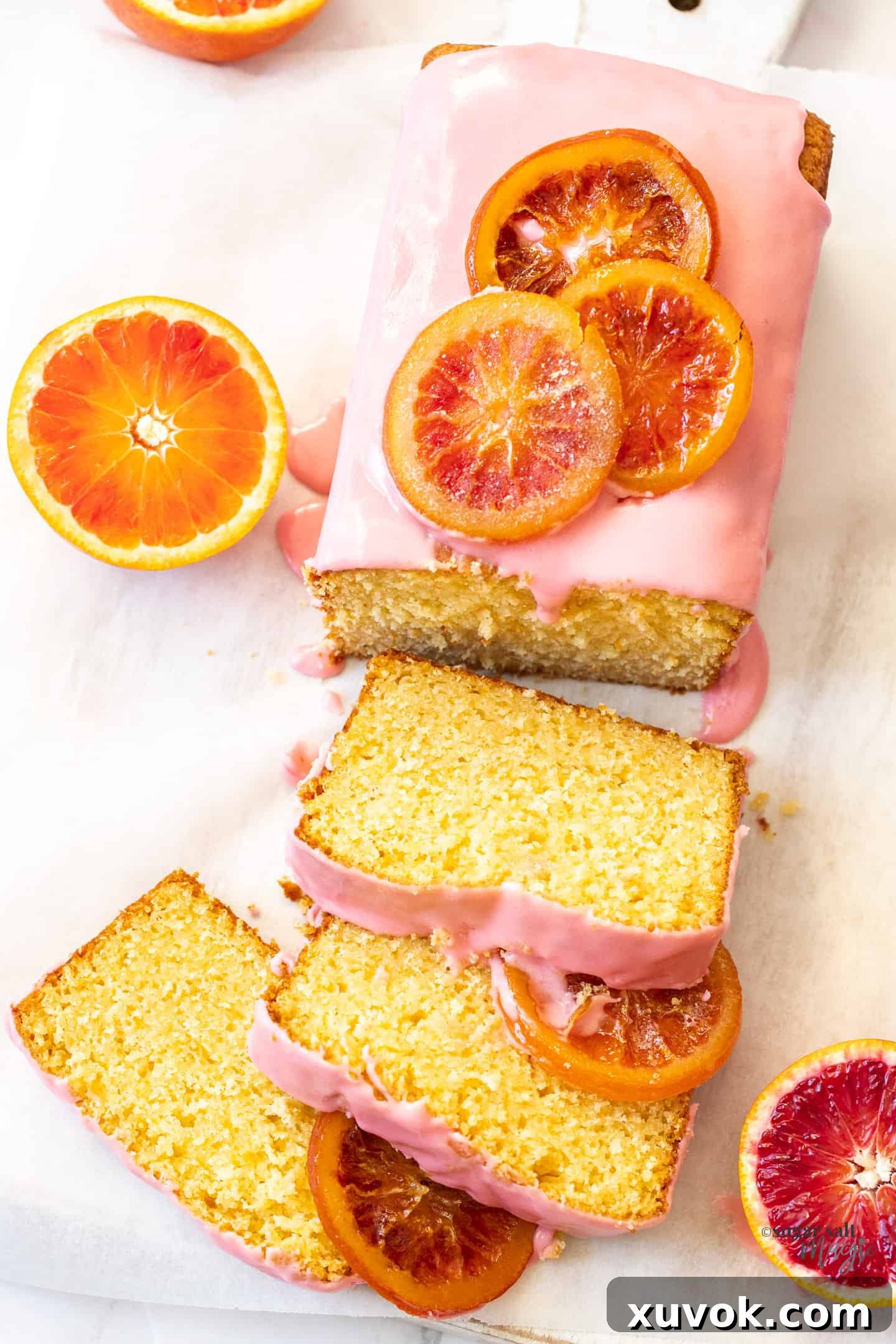 Top down view of an orange loaf cake with slices cut from it.