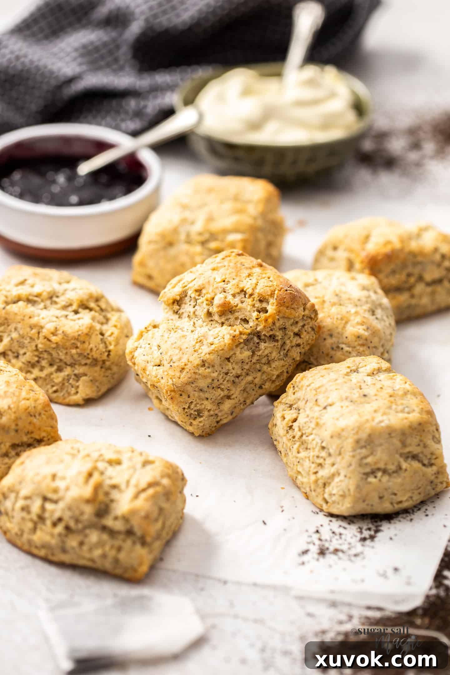 A fresh batch of golden-brown Earl Grey scones artfully arranged on a sheet of baking paper, just out of the oven and ready to be served.