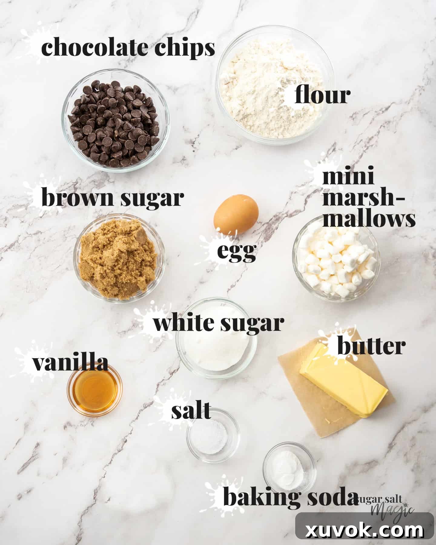 Ingredients for marshmallow chocolate chip cookies neatly arranged on a marble surface.