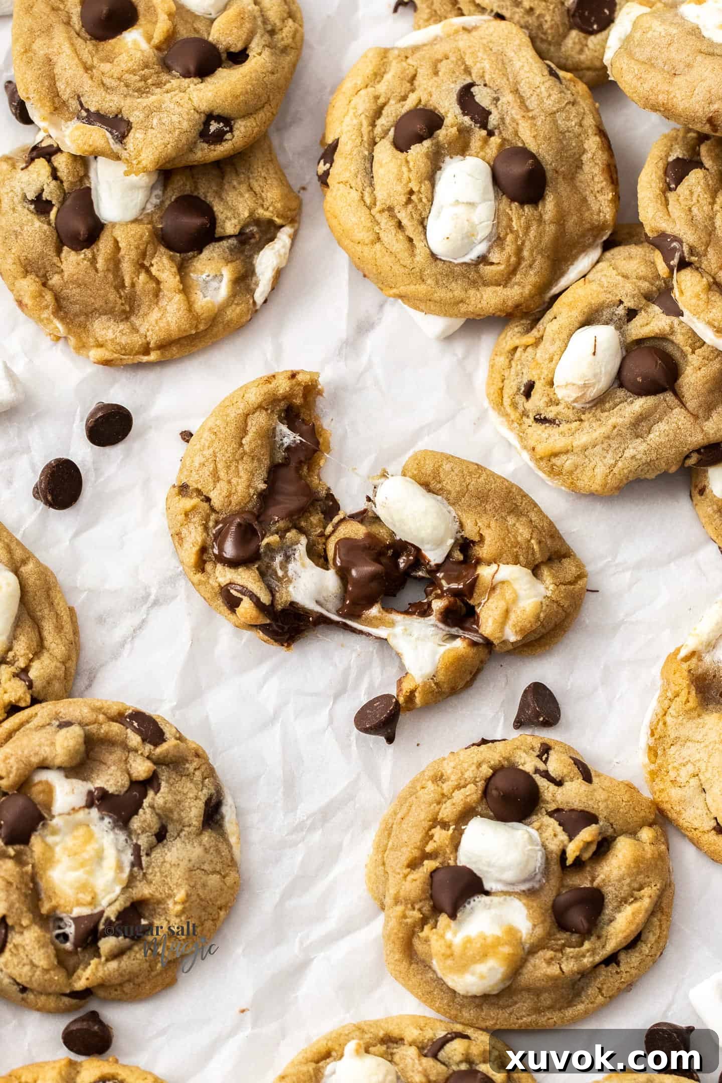 Top down view of a cookie that's been torn apart to show the gooey chocolate and marshmallows stretching.