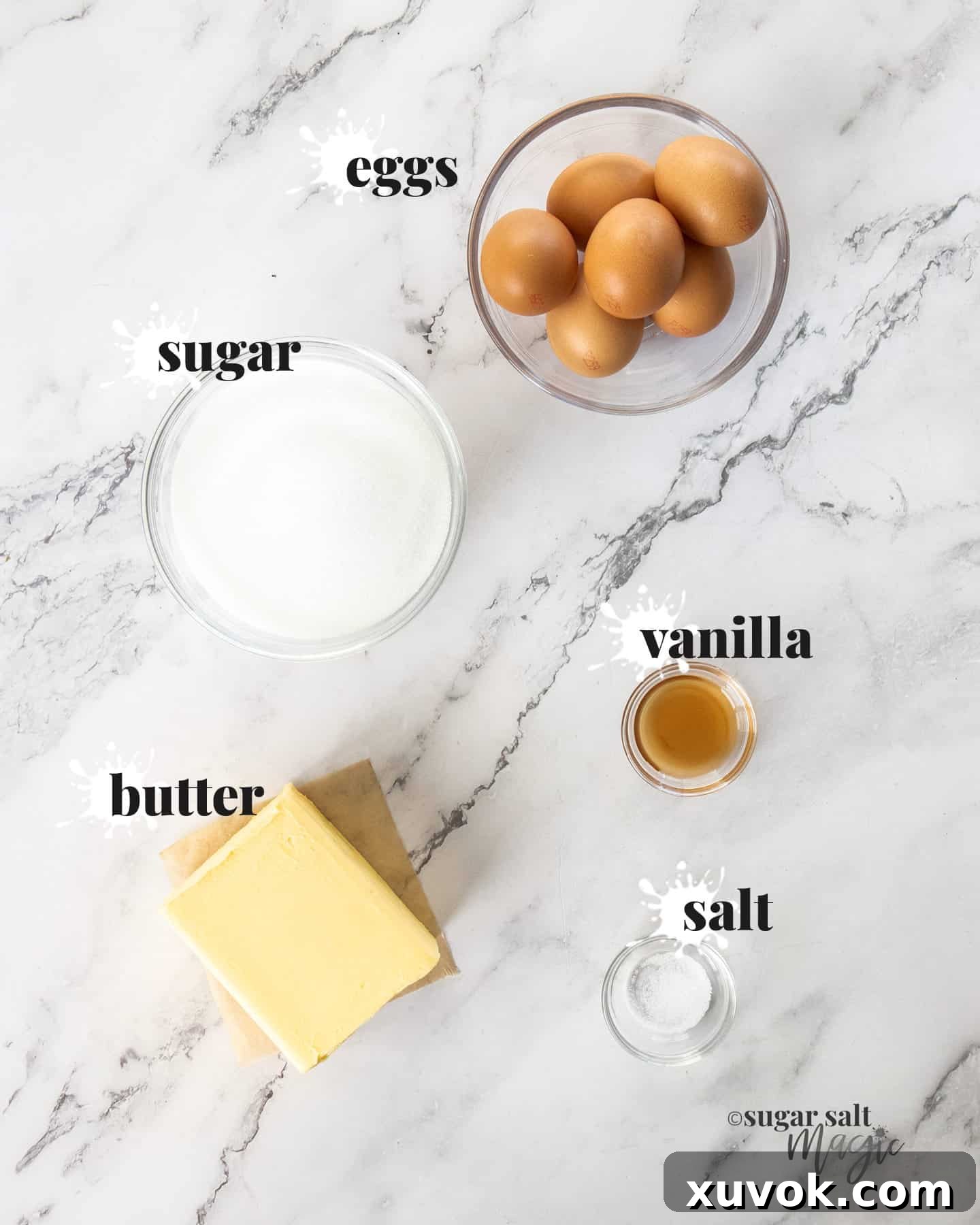 Ingredients for vanilla swiss meringue buttercream on a marble surface.