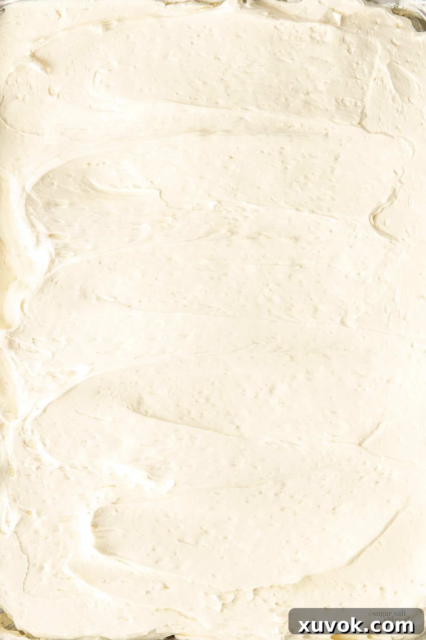 Swirls of Swiss meringue buttercream spread out on tray.