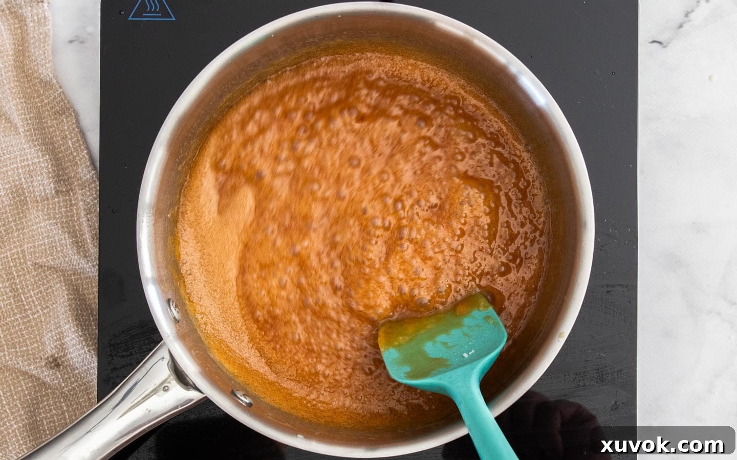 The caramel after cream has been stirred in, looking smooth and creamy.