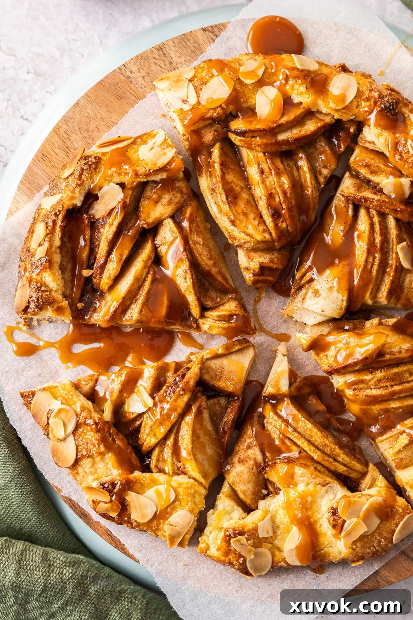 Top down view of an apple crostata cut into 6 slices, highlighting its rustic beauty and golden crust.
