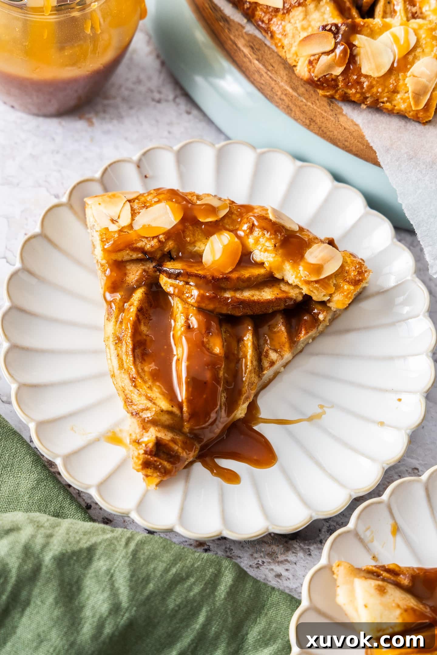 A perfectly baked slice of apple crostata on a dessert plate, ready to be enjoyed.