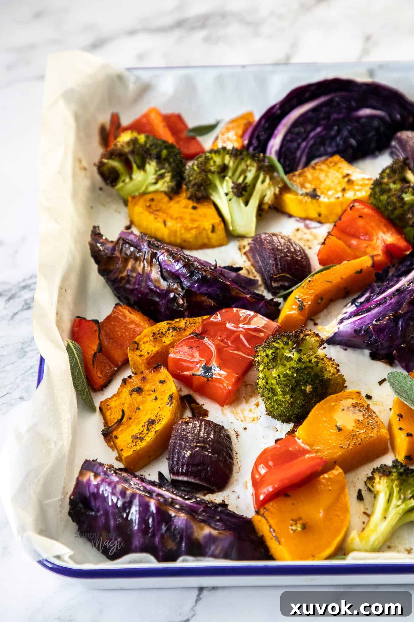 A sheet pan filled with colourful roasted vegetables, beautifully arranged and ready for the oven.