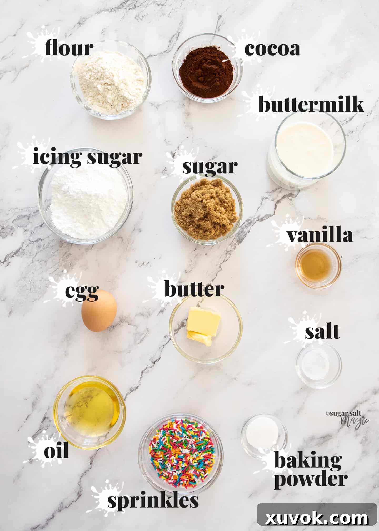 A beautiful flat lay of all the essential ingredients for making chocolate sprinkle donuts, neatly arranged on a pristine marble countertop, ready for baking.