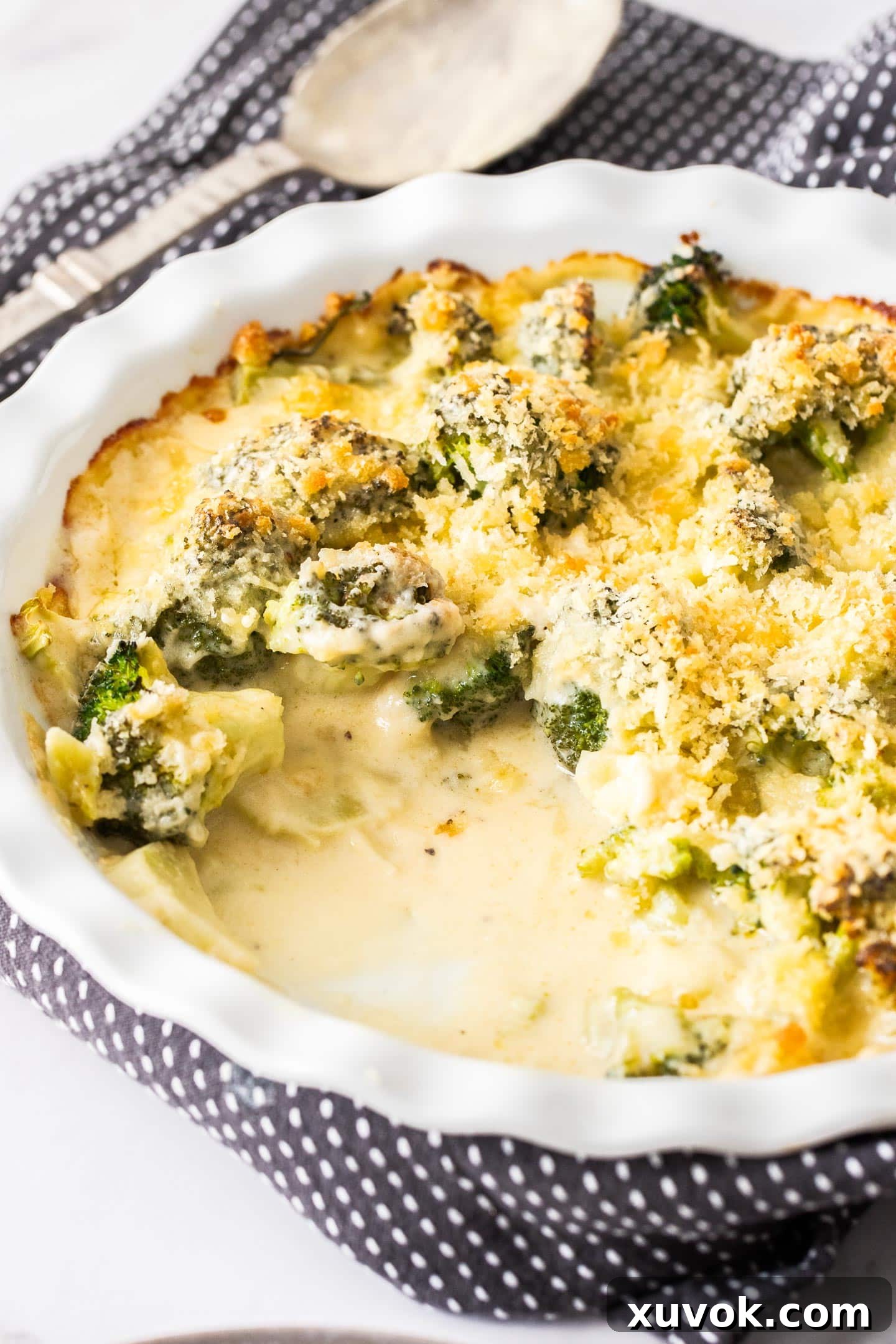 A baking dish filled with broccoli cheese bake showing the creamy sauce.