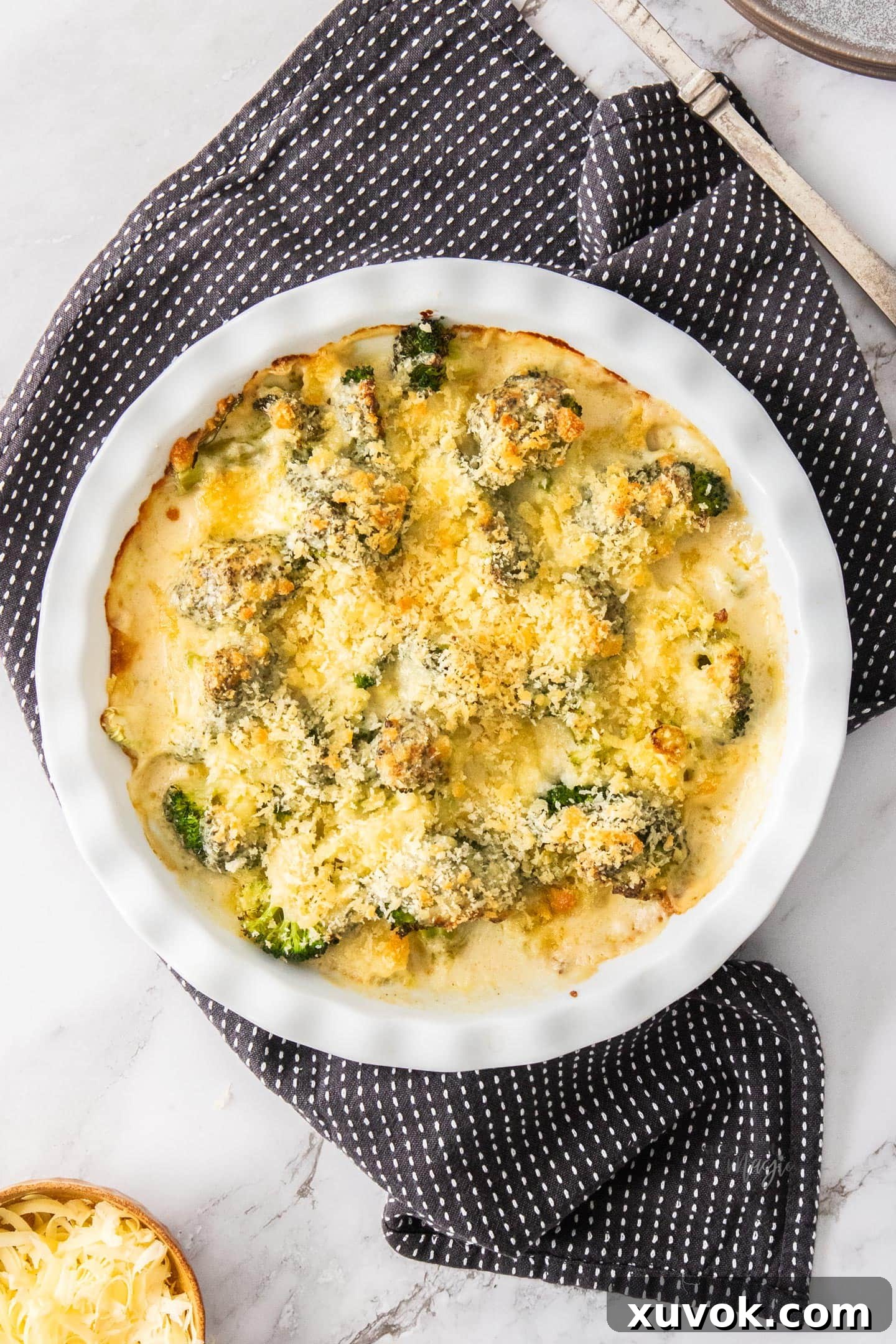 Top down view of broccoli cheese bake in a pie dish.