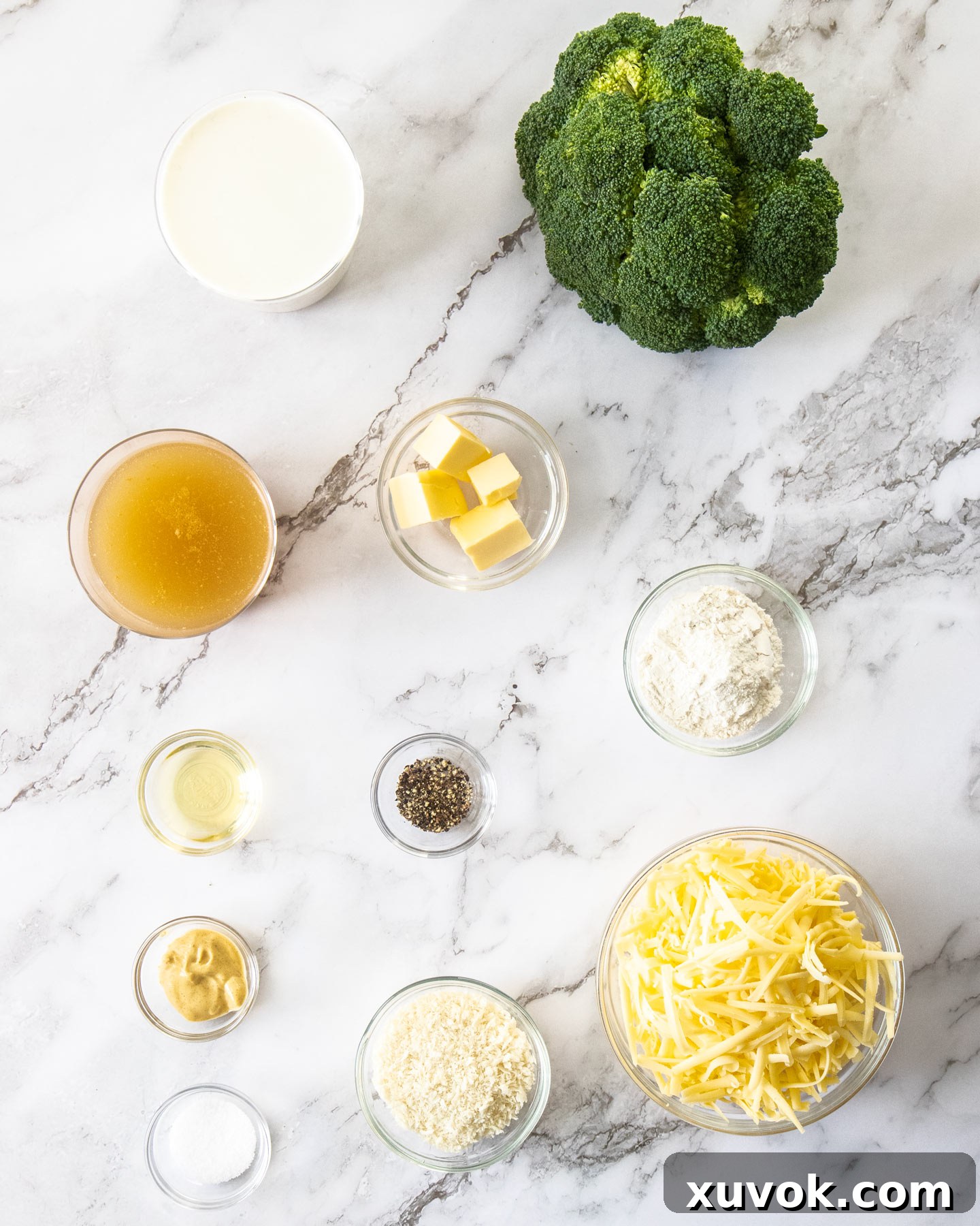 Ingredients for broccoli cheese bake on a marble surface.