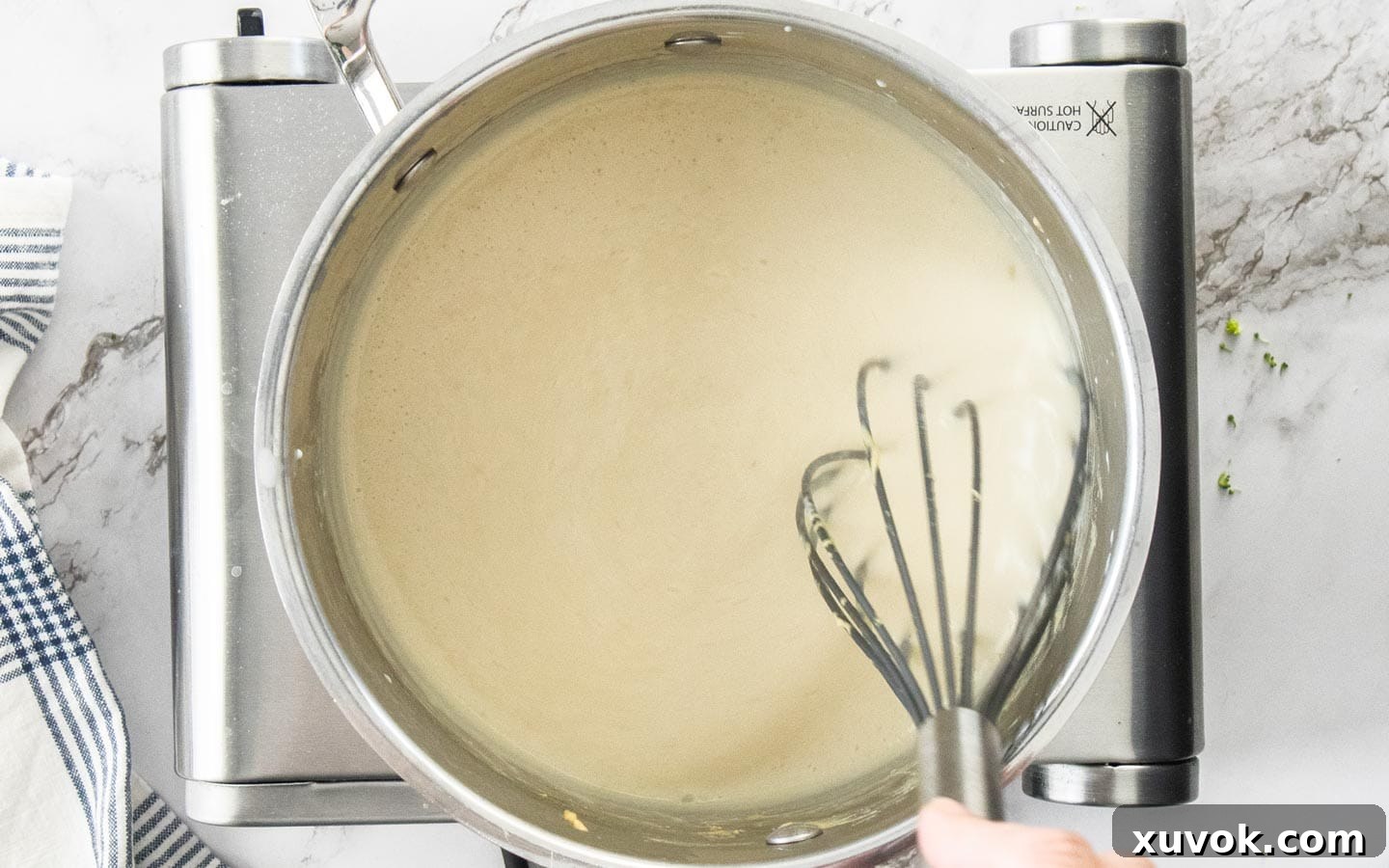 The sauce thickening in the pan.
