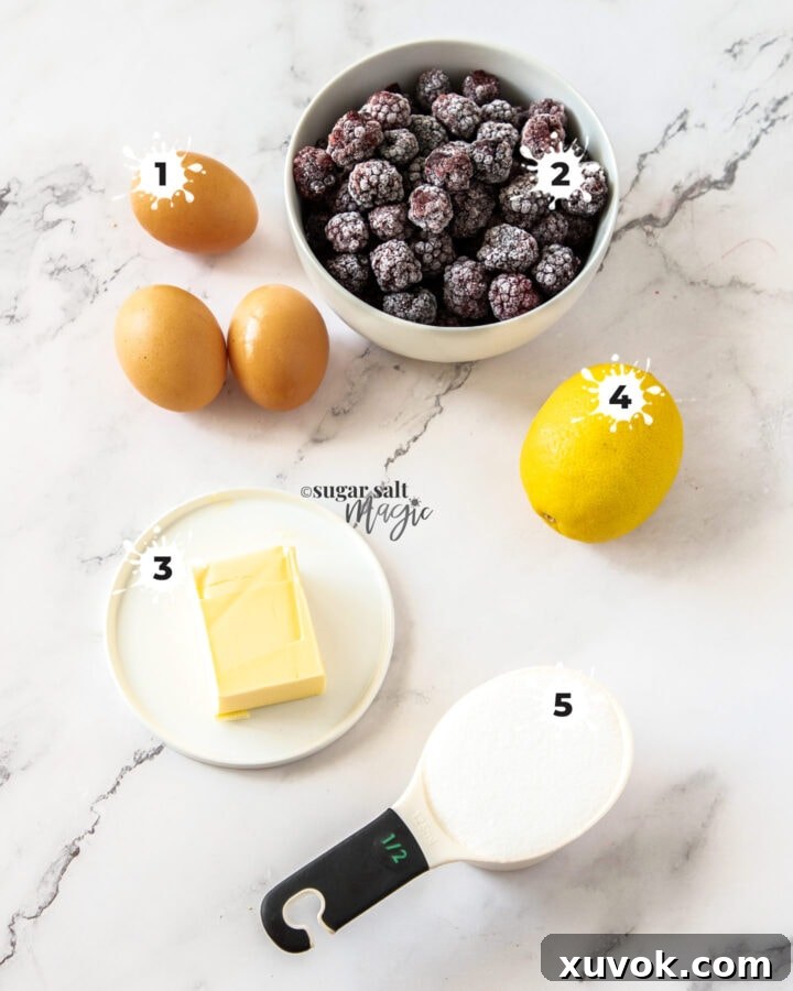 Ingredients for homemade blackberry curd laid out aesthetically on a marble background, including fresh blackberries, whole eggs and egg yolks, unsalted butter, caster sugar, and fresh lemon juice, emphasizing simplicity and quality.