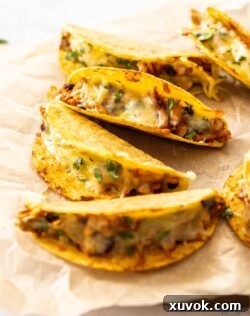 Baked tacos on a sheet of baking paper.