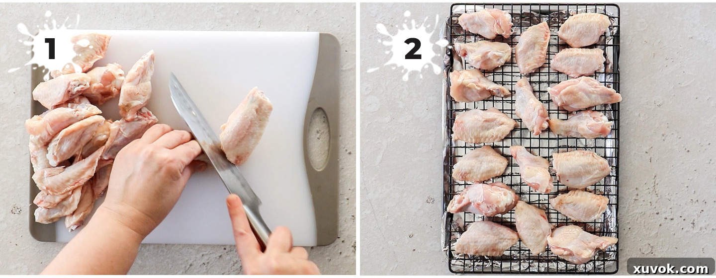 Chicken wings on a white cutting board, being expertly cut into drumettes and flats.
