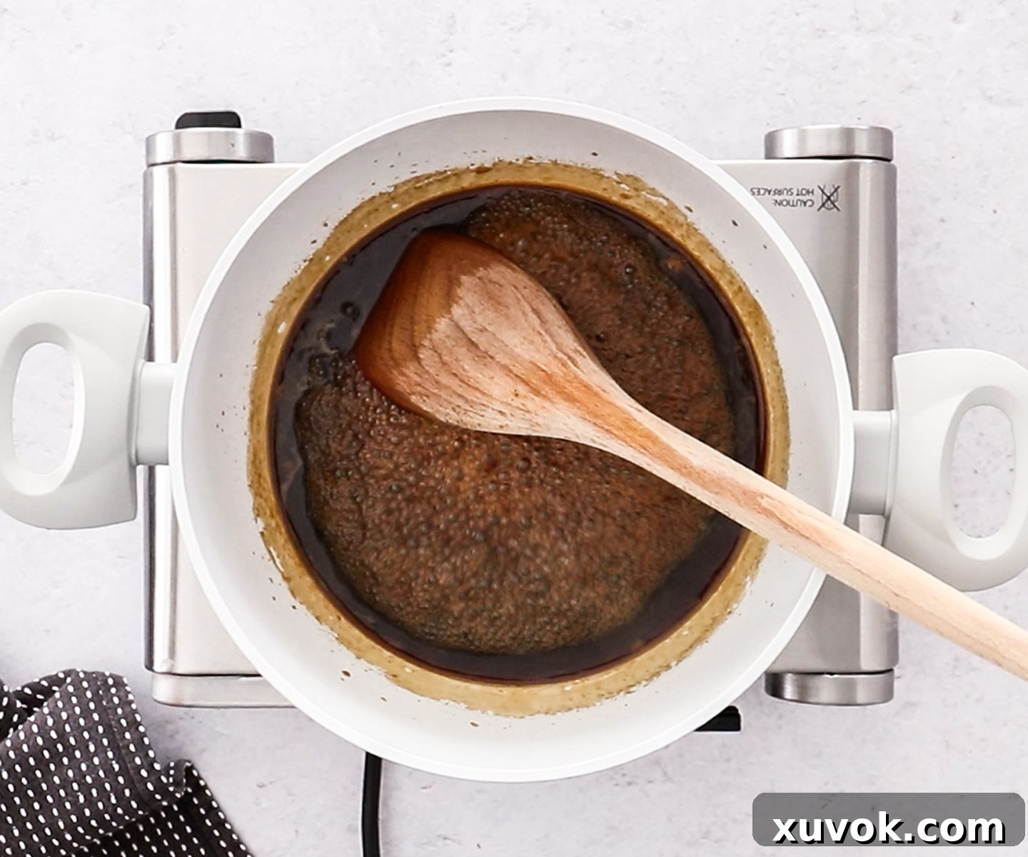 The homemade teriyaki sauce gently reducing in a saucepan, creating a concentrated base for the glaze.