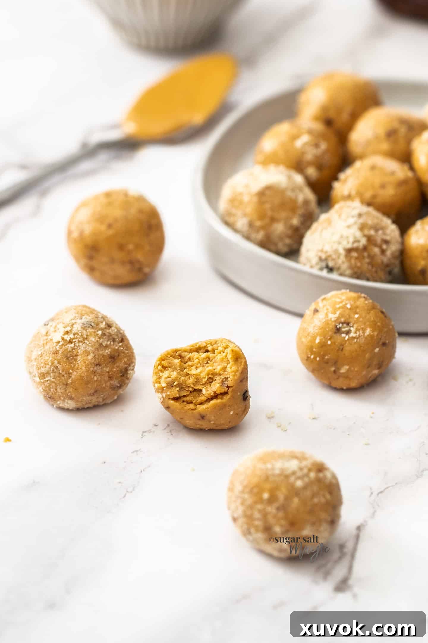 Closeup of a peanut butter bliss ball with a bite taken out, showing the rich, chewy interior. A healthy and delicious treat.