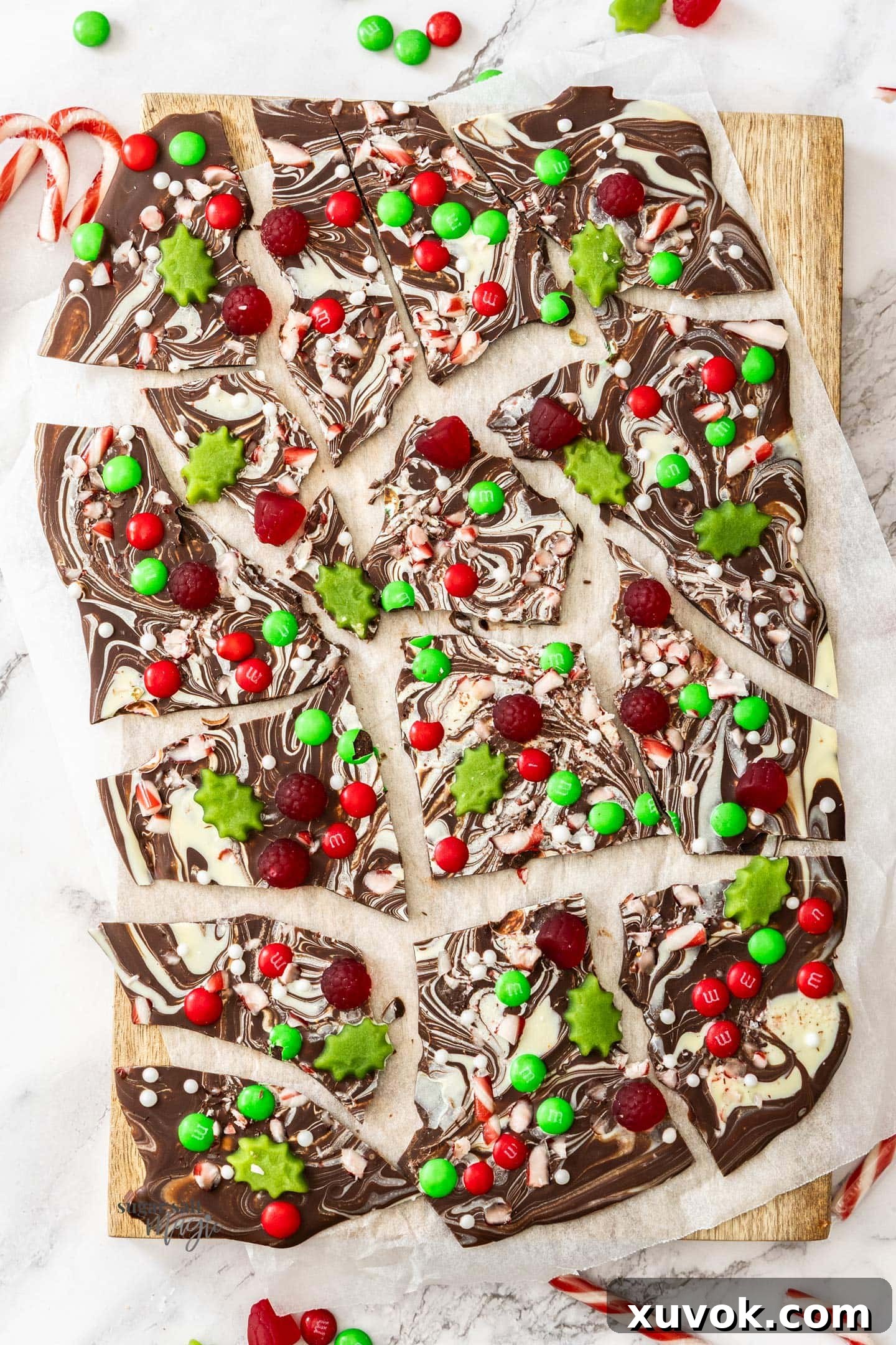 Top down view of chocolate Christmas bark generously topped with colorful Christmas candy.