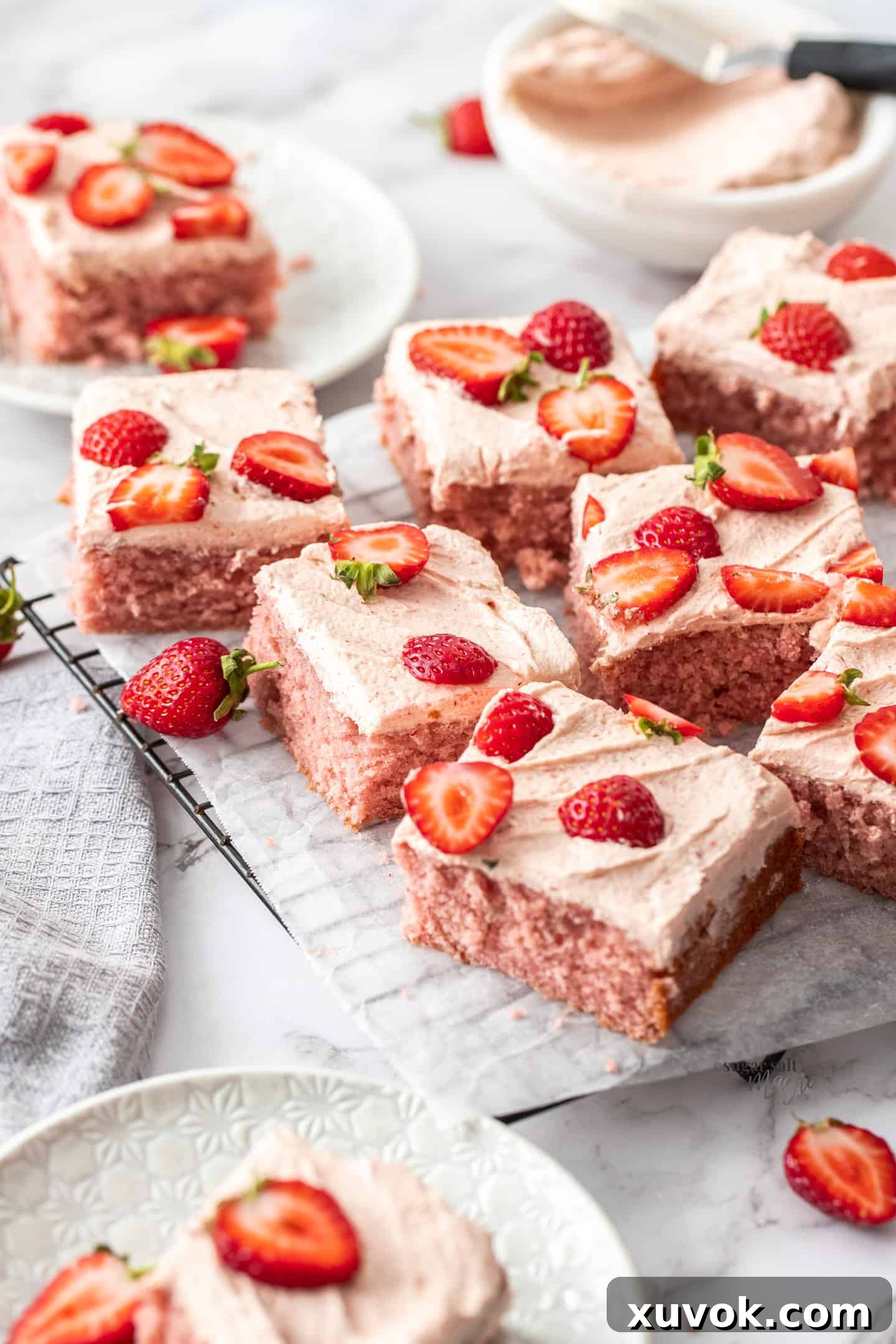 7 slices of strawberry cake on a wire rack, ready to be served.