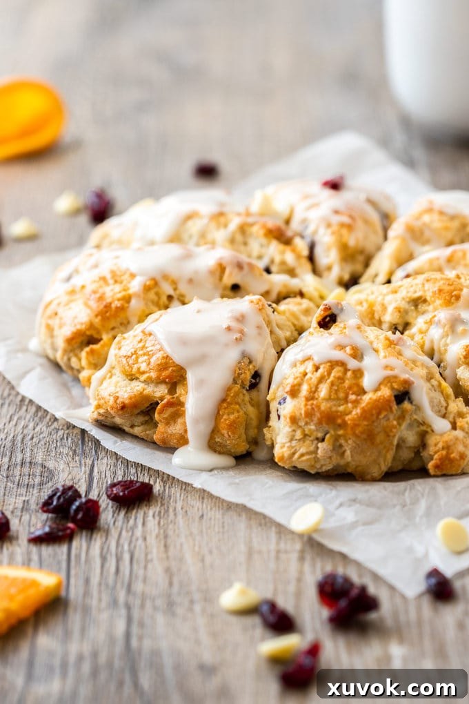 Delicate White Chocolate Cranberry Scones with a sweet glaze, perfect for Christmas brunch.