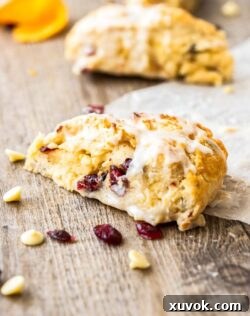 Close-up of a festive White Chocolate Cranberry Scone, ready to be served.