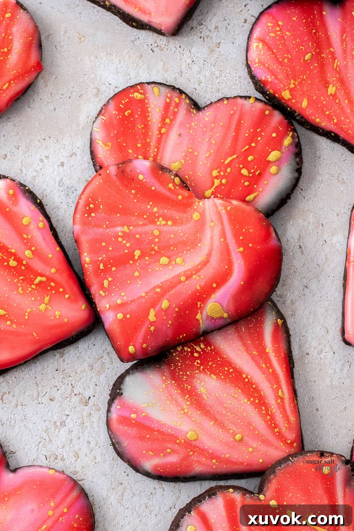 Closeup of 3 iced chocolate sugar cookies.