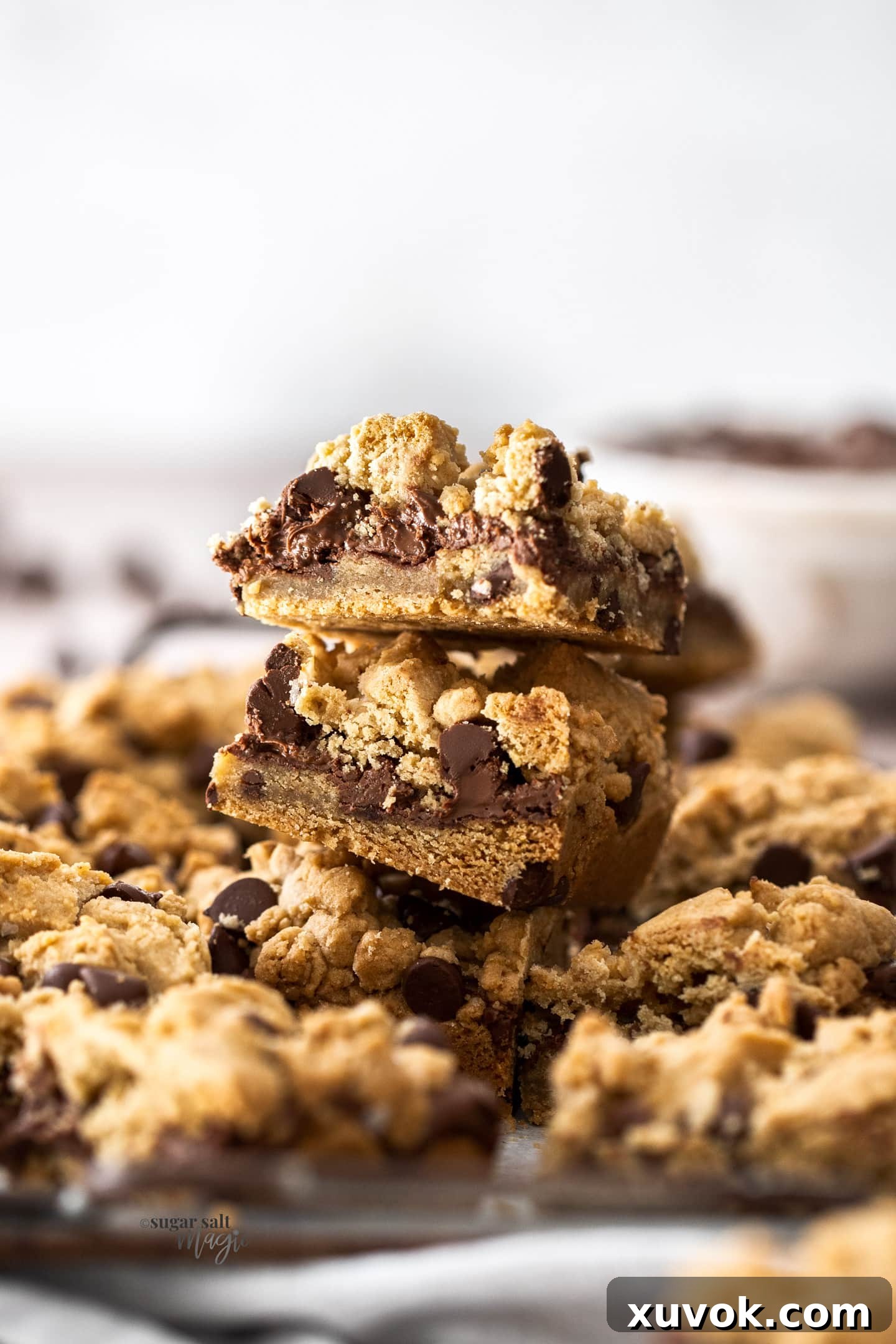 A tempting stack of freshly baked chocolate chip Nutella bars, showcasing their gooey layers and rich texture.
