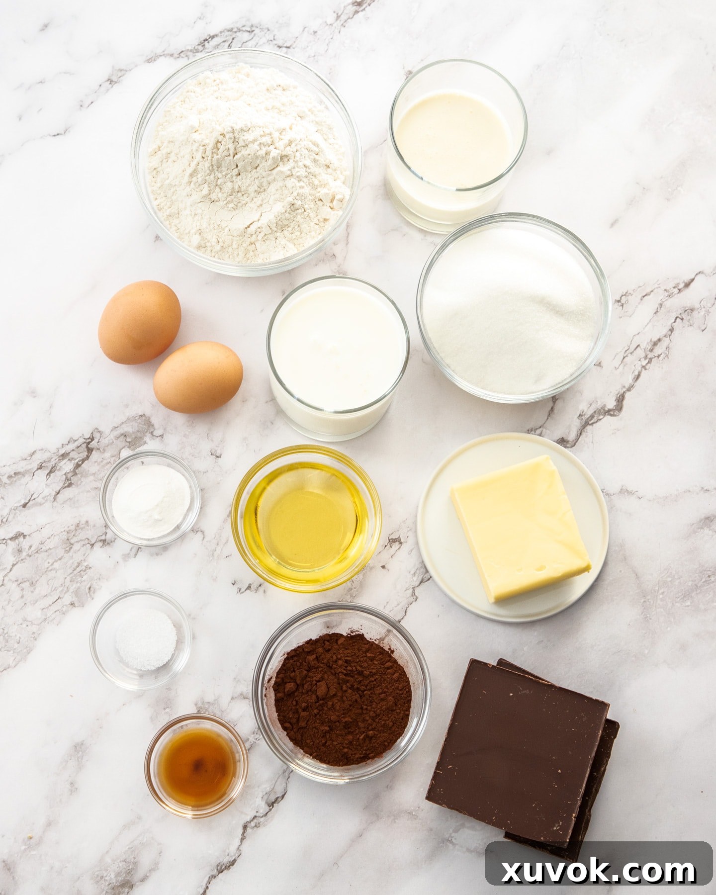 Ingredients for marble loaf cake on a marble surface.