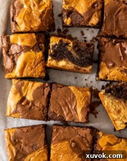 Top down view of brownie blondies on a sheet of baking paper.