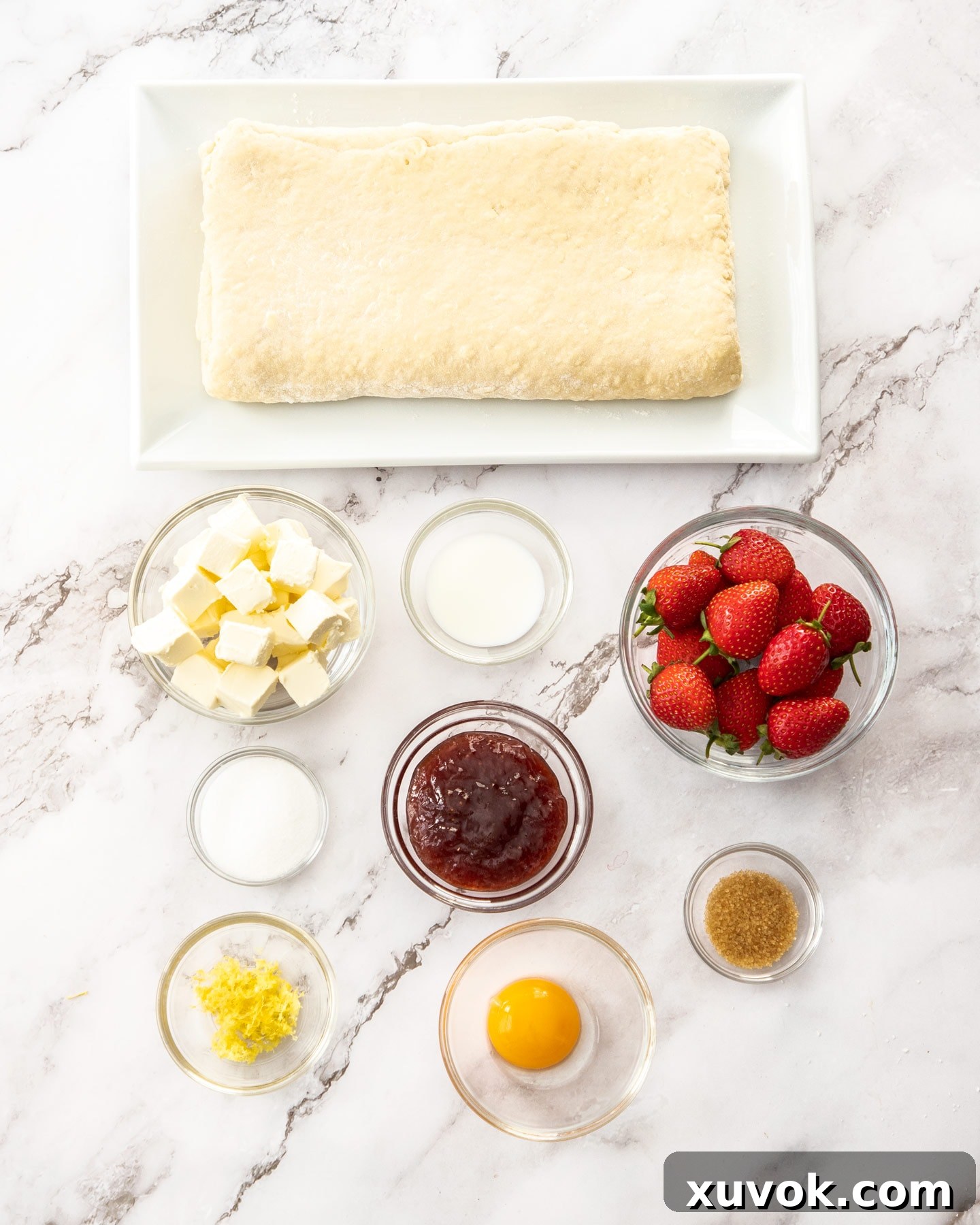 Ingredients for strawberry danishes, neatly arranged before baking.