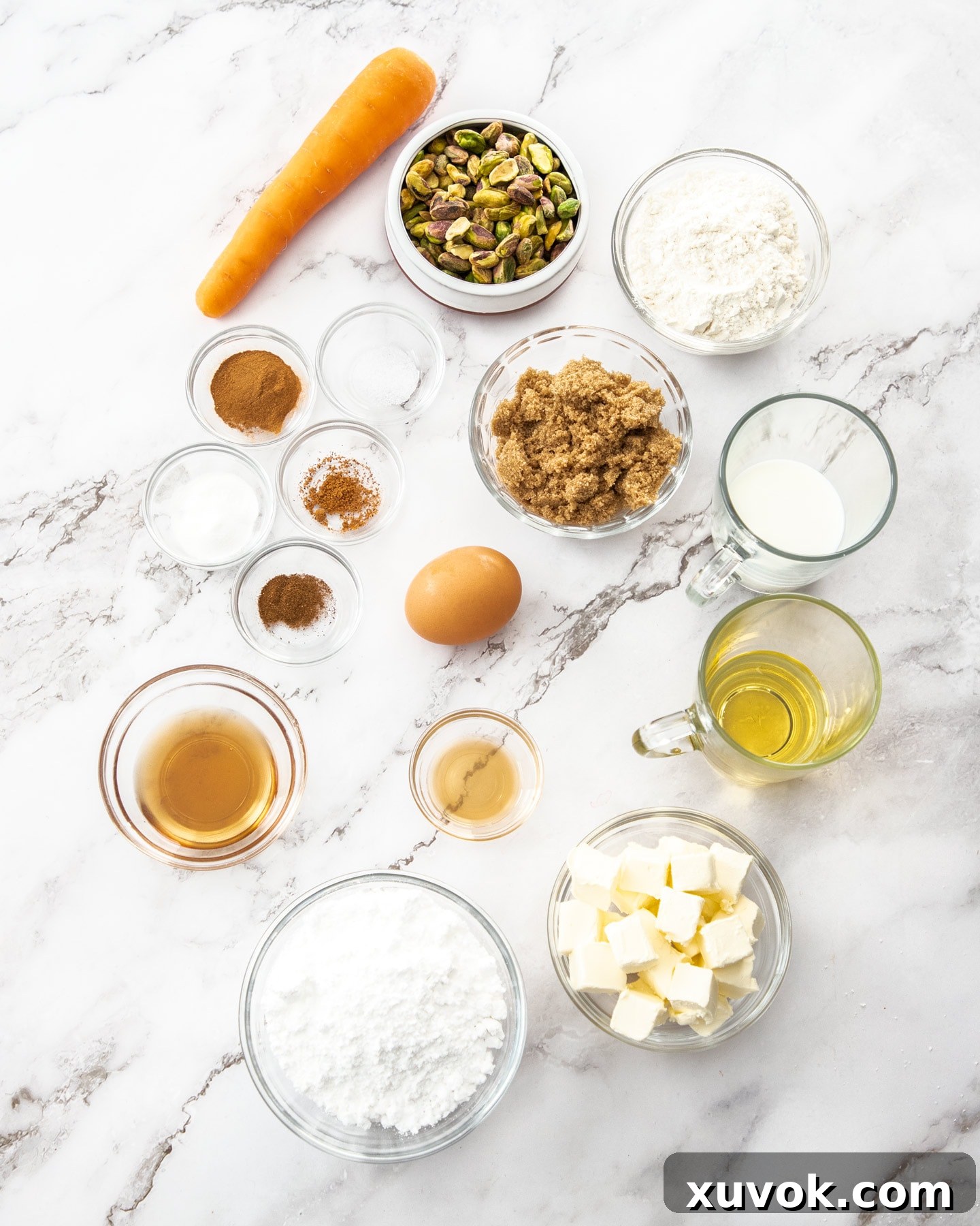 Ingredients for carrot cake donuts on a marble surface.